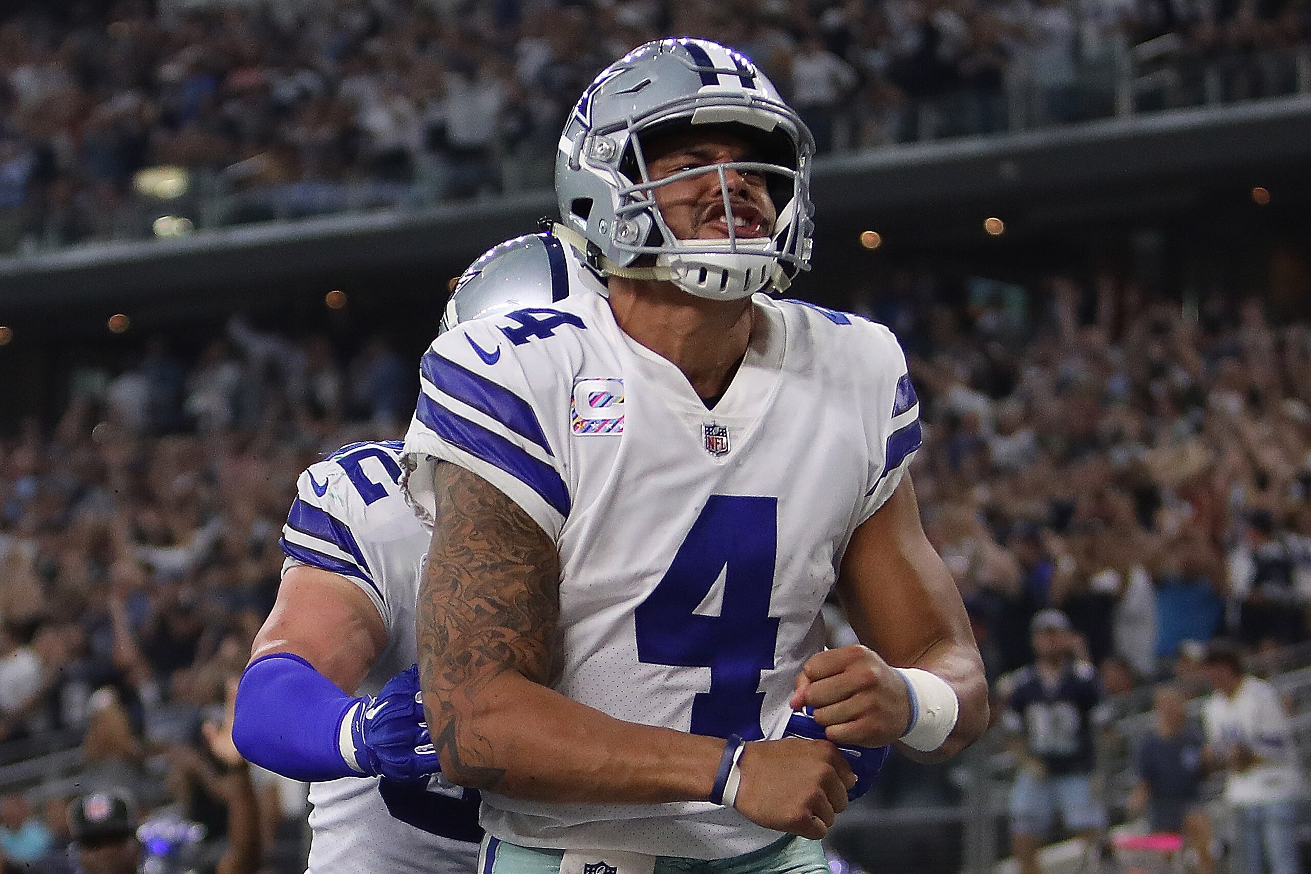 ARLINGTON, TX - OCTOBER 08:  Dak Prescott #4 celebrates his touchdown run with Jason Witten #82 of the Dallas Cowboys in the fourth quarter against the Green Bay Packers at AT&T Stadium on October 8, 2017 in Arlington, Texas.  (Photo by Ronald Martinez/Ge