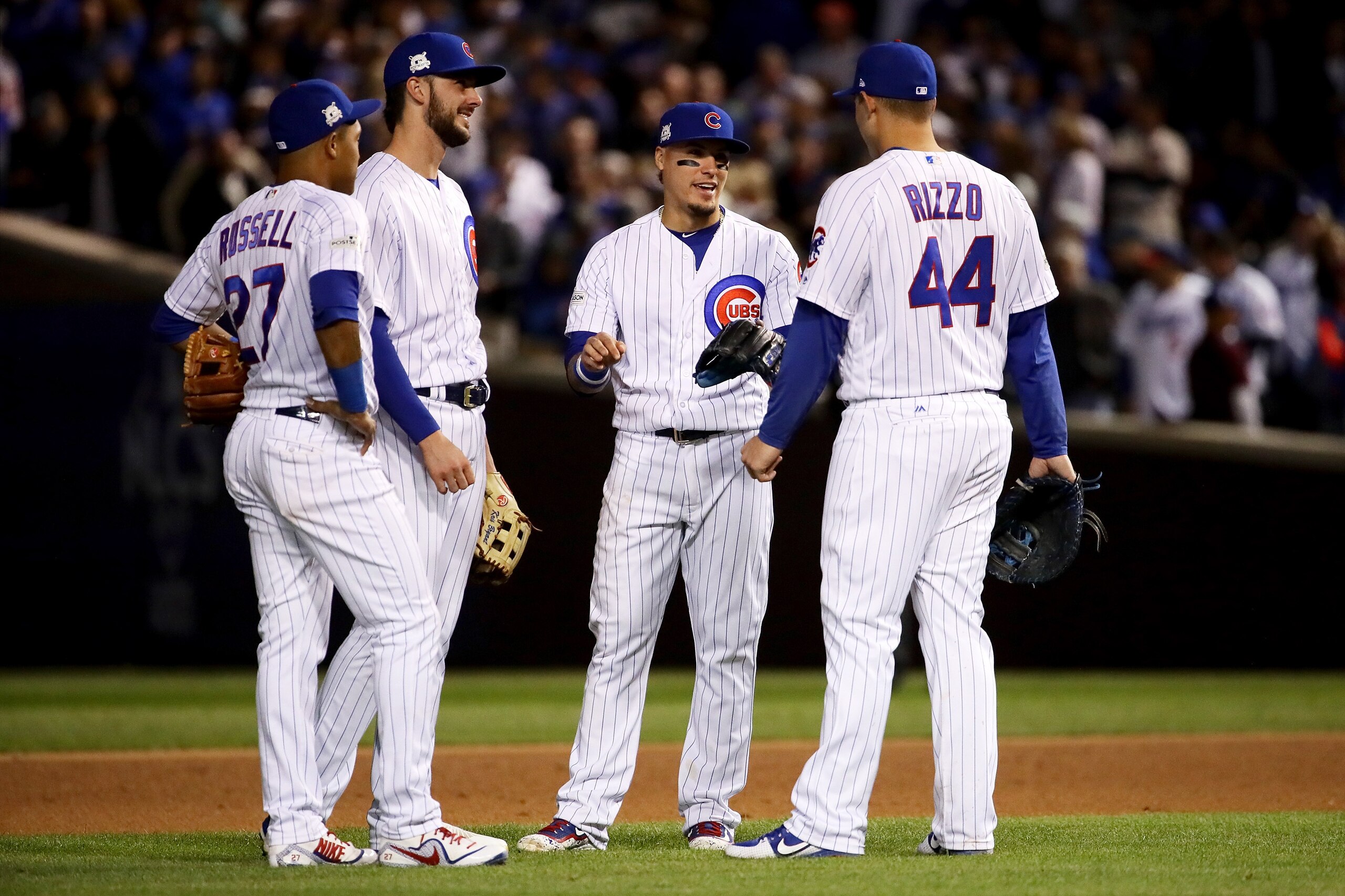 CHICAGO, IL - OCTOBER 18: Kris Bryant #17, Addison Russell #27, Javier Baez #9, and Anthony Rizzo #44 of the Chicago Cubs meet during a pitching change in the seventh inning against the Los Angeles Dodgers during game four of the National League Champion CHICAGO, IL - OCTOBER 18: Kris Bryant #17, Addison Russell #27, Javier Baez #9, and Anthony Rizzo #44 of the Chicago Cubs meet during a pitching change in the seventh inning against the Los Angeles Dodgers during game four of the National League Champion