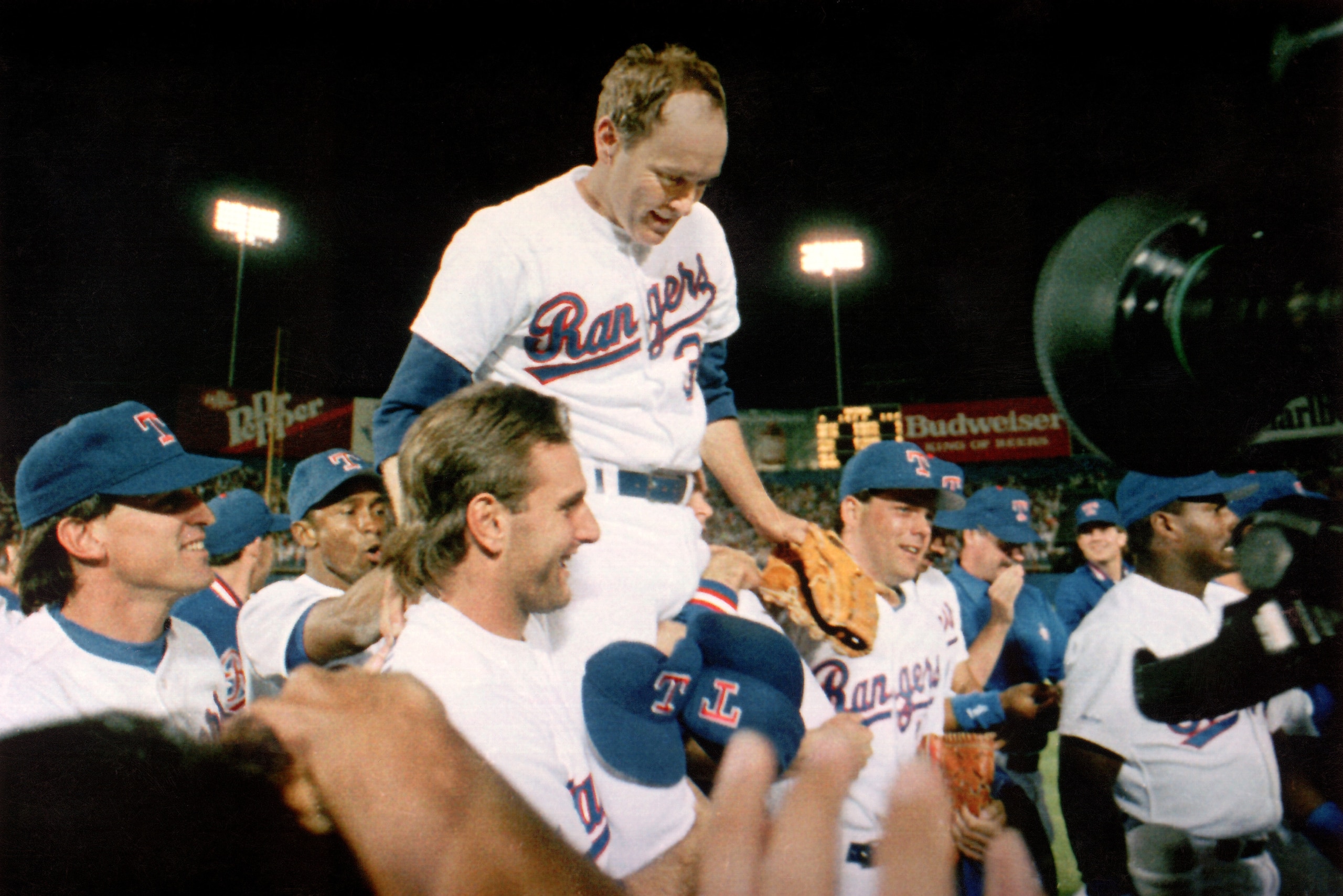 ARLINGTON, TX - MAY 1:  Pitcher Nolan Ryan #34 of the Texas Rangers is carried off the field by his teammates, after Ryan's seventh no-hitter of his carrer against the Toronto Blue Jays at Arlington Stadium on May 1, 1991 in Arlington, Texas.  (Photo by L