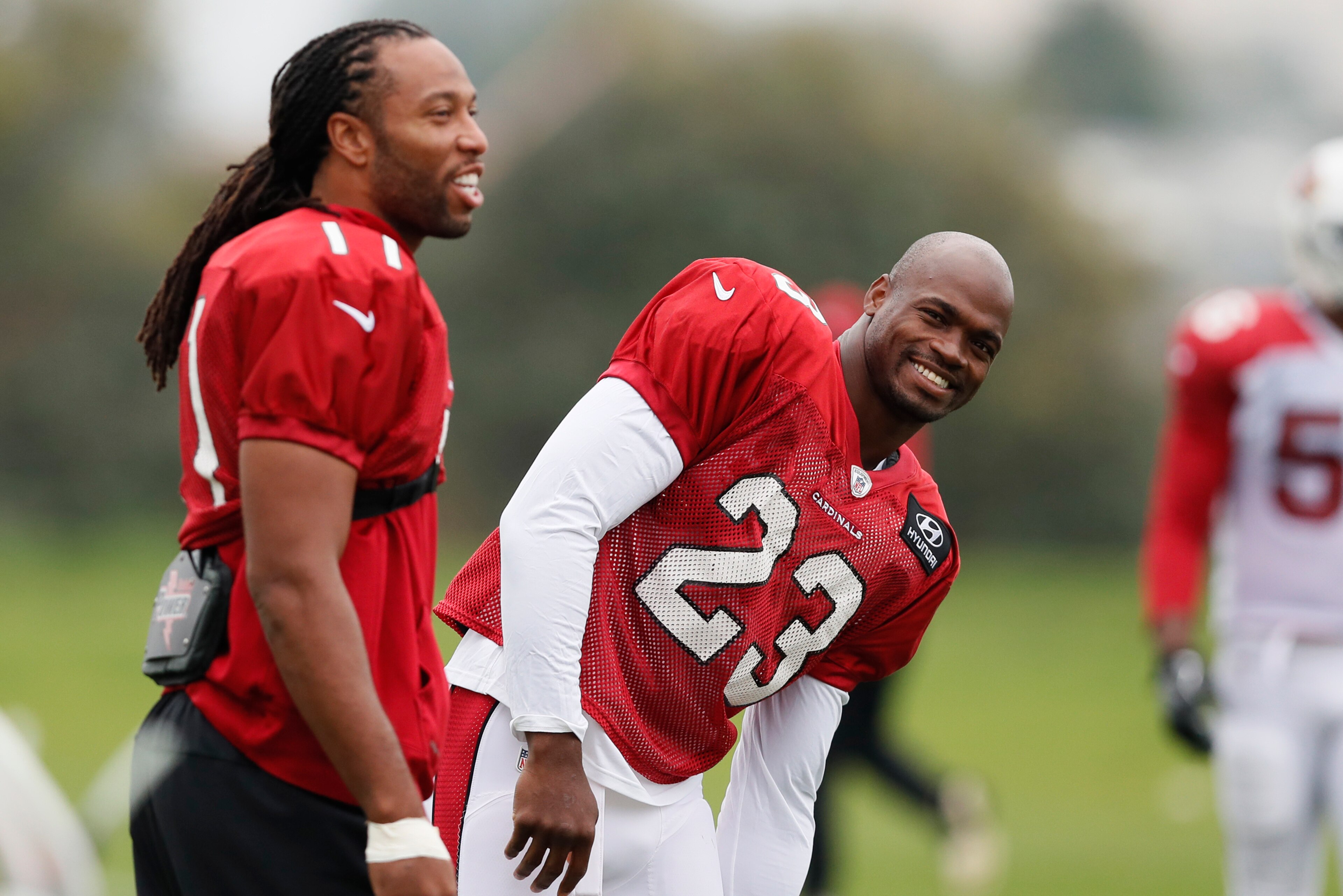 Larry Fitzgerald, left, and Adrian Peterson