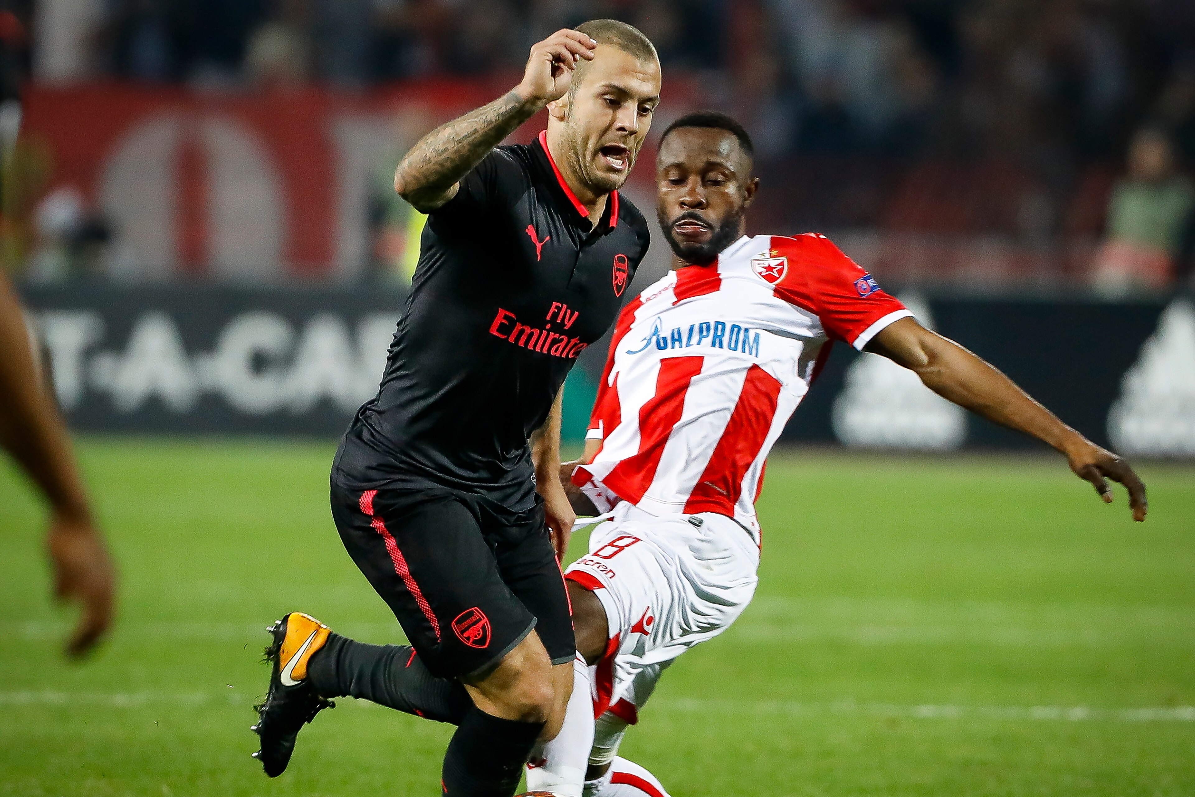BELGRADE, SERBIA - OCTOBER 19: Jack Wilshere (L) of Arsenal in action against Guelor Kanga (R) of Crvena Zvezda during the UEFA Europa League group H match between Crvena Zvezda and Arsenal FC at Rajko Mitic Stadium on October 19, 2017 in Belgrade, Serbia