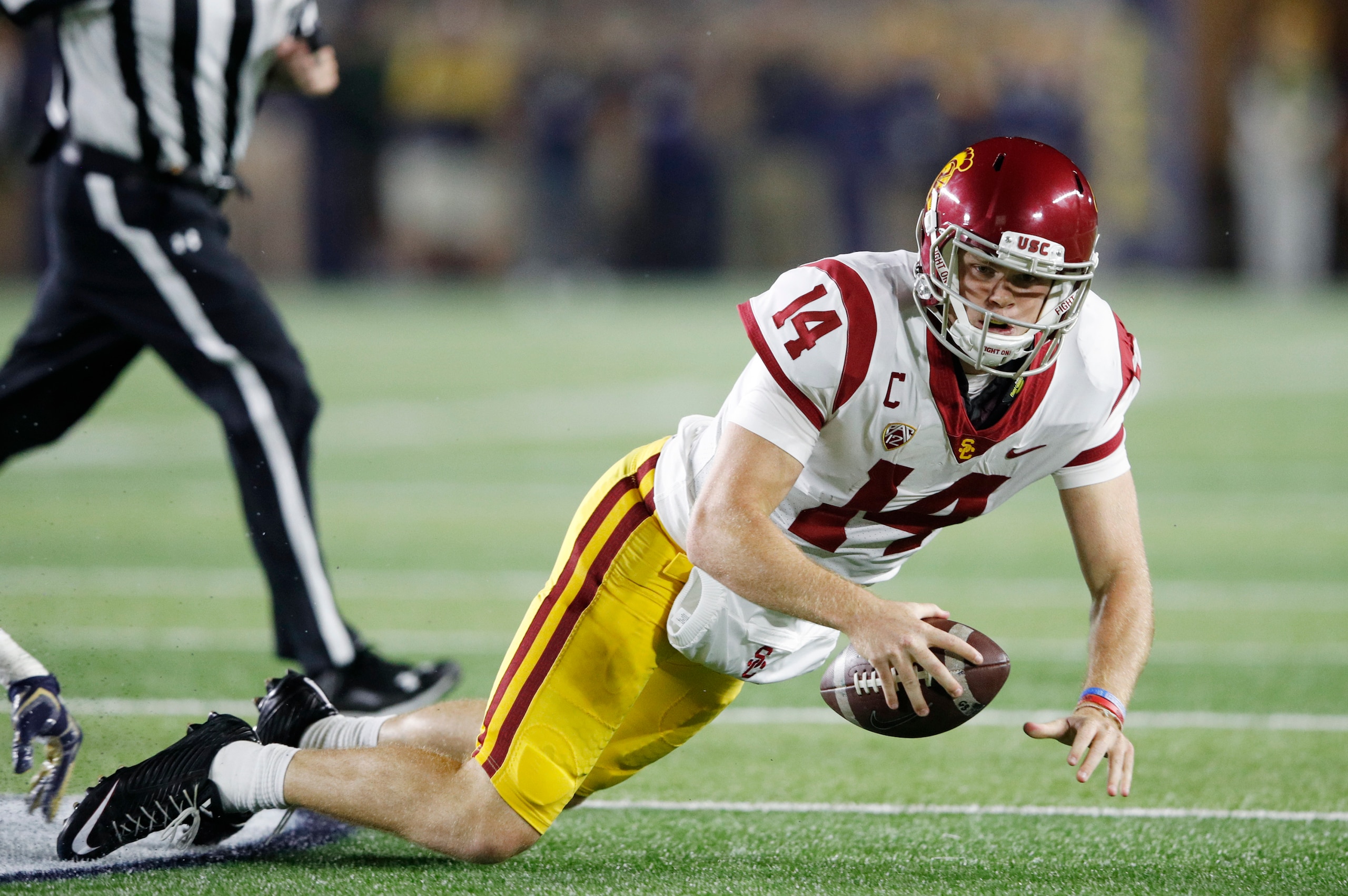 SOUTH BEND, IN - OCTOBER 21: Sam Darnold #14 of the USC Trojans gets tackled while trying to pass in the second quarter of a game against the Notre Dame Fighting Irish at Notre Dame Stadium on October 21, 2017 in South Bend, Indiana. (Photo by Joe Robbins