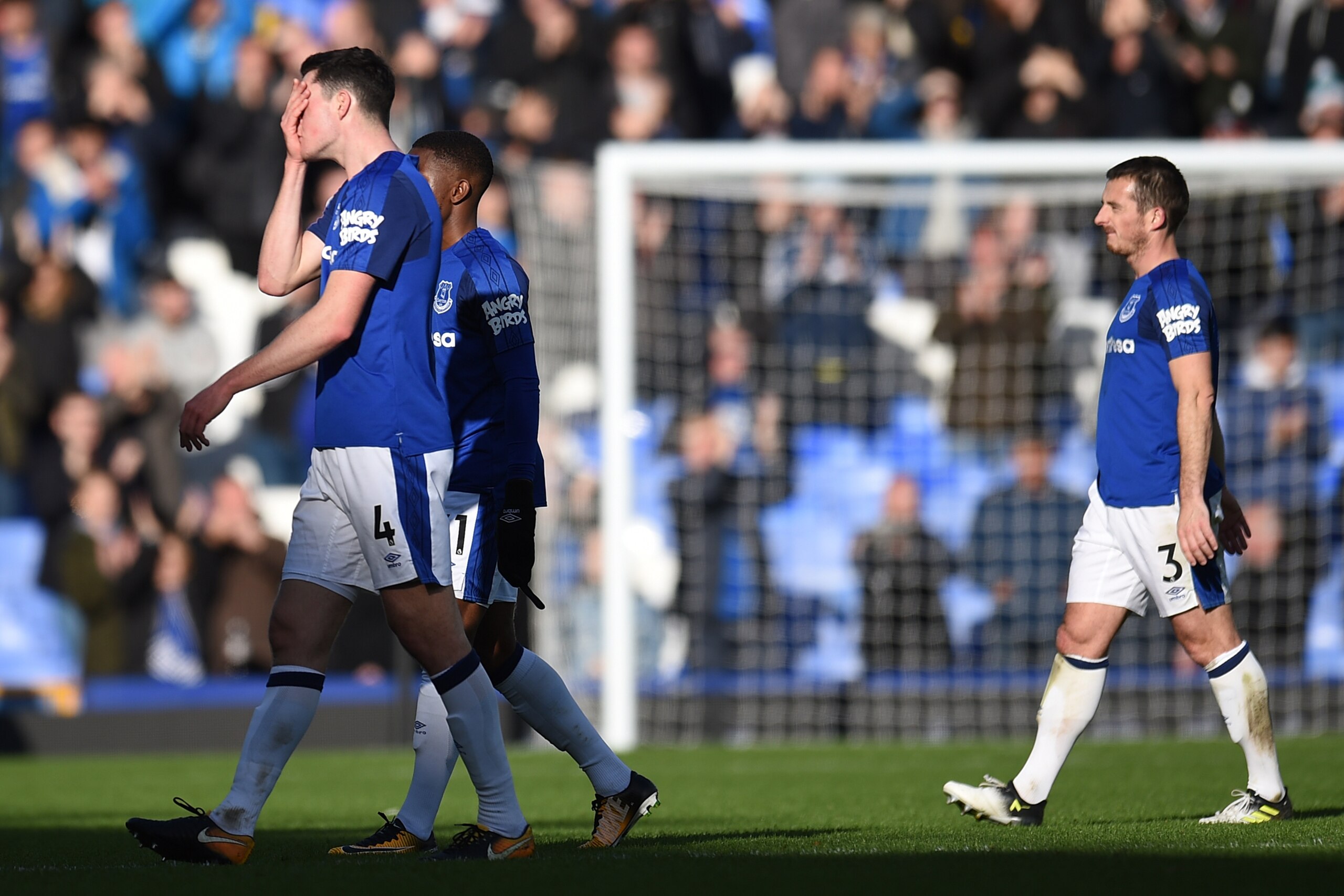 Everton's English defender Michael Keane (L) and Everton's English defender Leighton Baines (R) reacts at the end of  the English Premier League football match between Everton and Arsenal at Goodison Park in Liverpool, north west England on October 22, 20