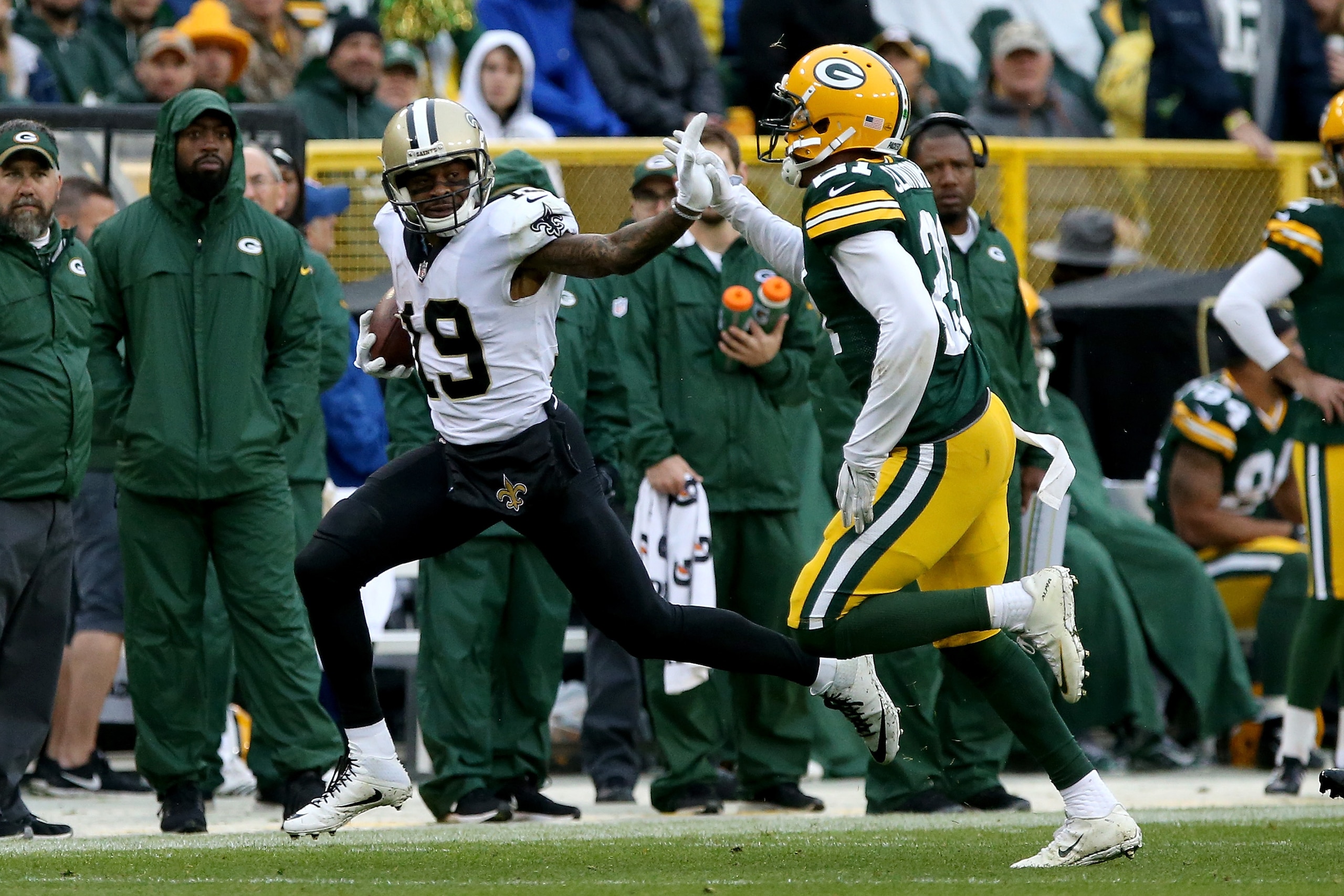 GREEN BAY, WI - OCTOBER 22:  Ted Ginn Jr. #19 of the New Orleans Saints runs with the ball while being chased by Ha Ha Clinton-Dix #21 of the Green Bay Packers in the third quarter at Lambeau Field on October 22, 2017 in Green Bay, Wisconsin. (Photo by Dy