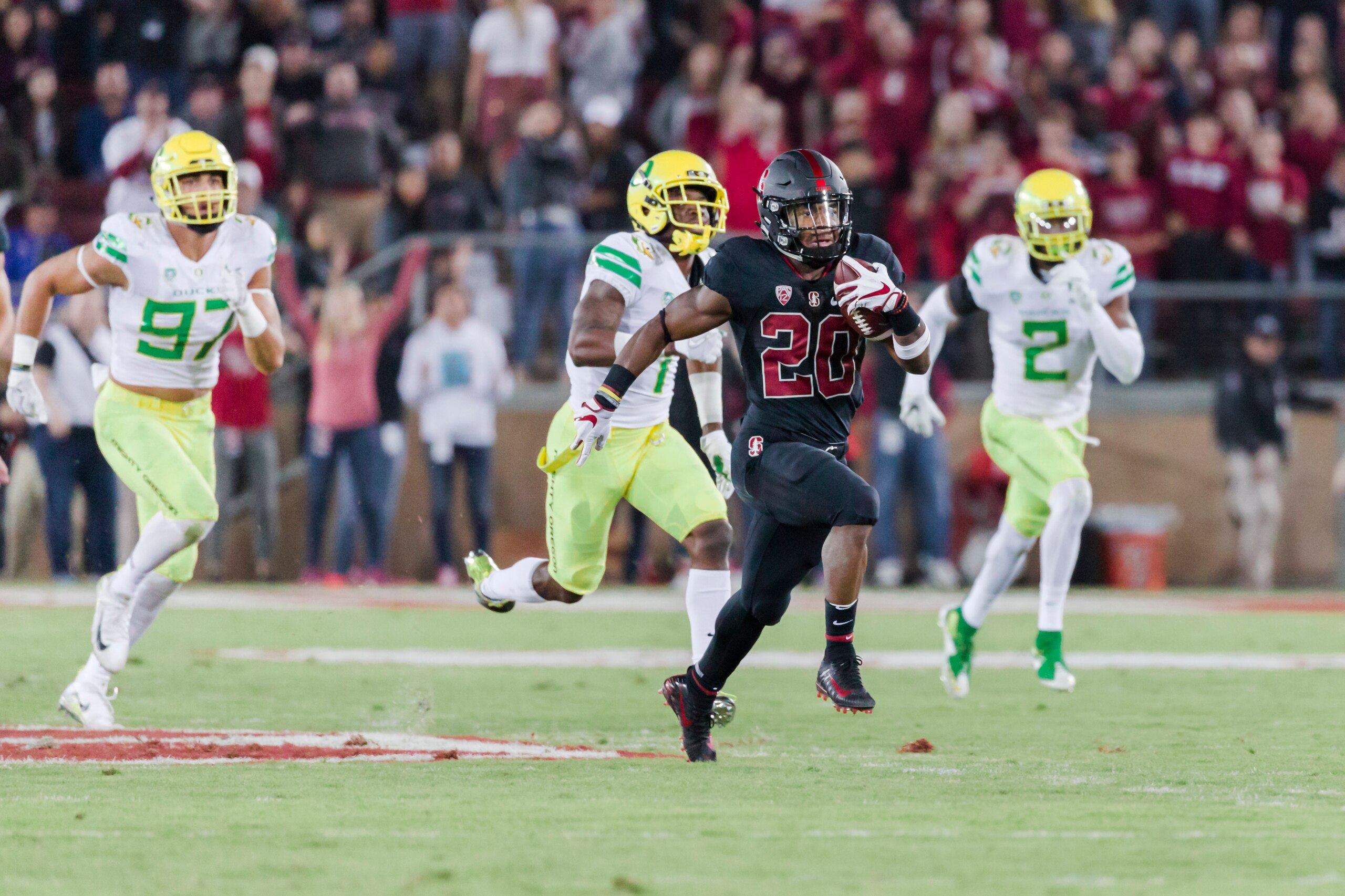 PALO ALTO, CA - OCTOBER 14:  Bryce Love #20 of the Stanford Cardinal runs with the ball during an NCAA Pac-12 football game against the University of Oregon Ducks on October 14, 2017 at Stanford Stadium in Palo Alto, California.  Oregon defenders are Jale