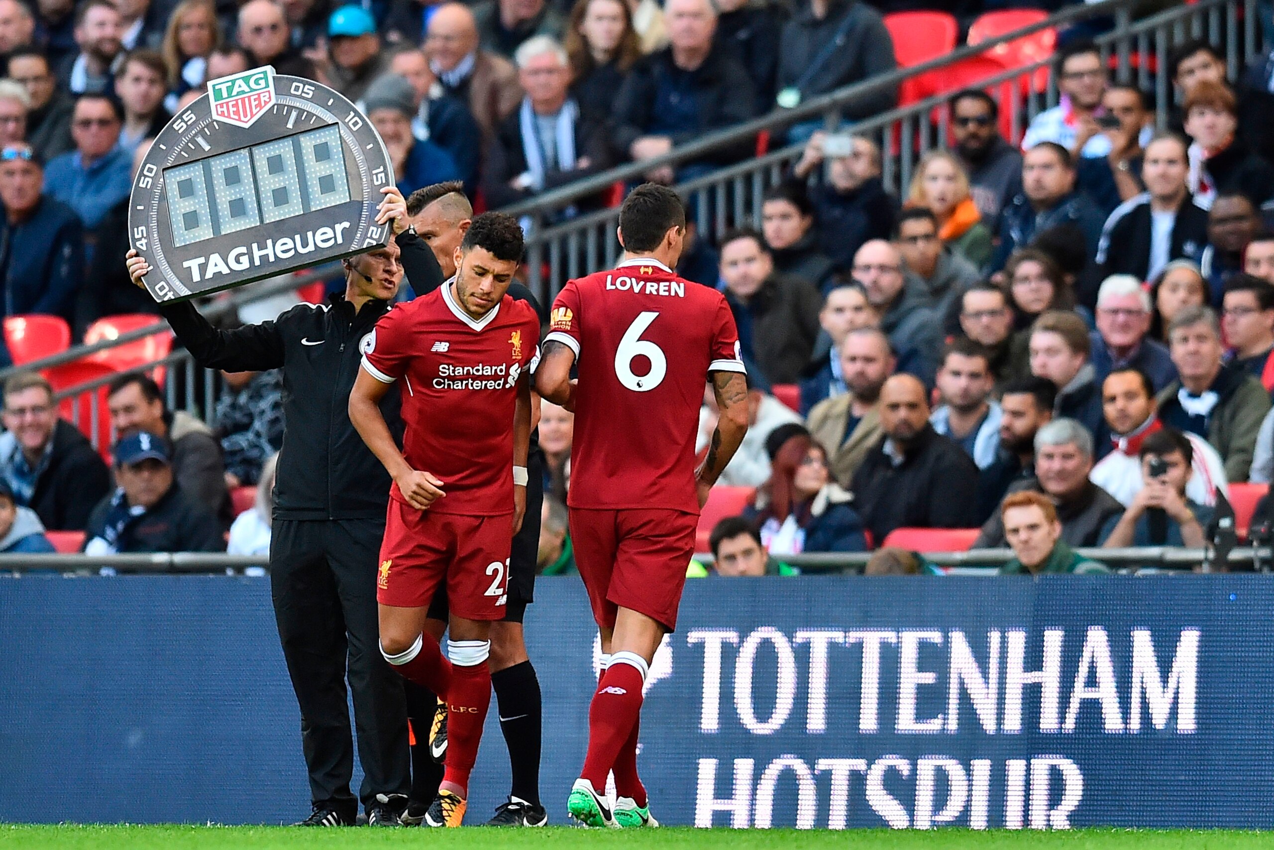 Liverpool's Croatian defender Dejan Lovren (R) is substituted for Liverpool's English midfielder Alex Oxlade-Chamberlain during the English Premier League football match between Tottenham Hotspur and Liverpool at Wembley Stadium in London, on October 22, 