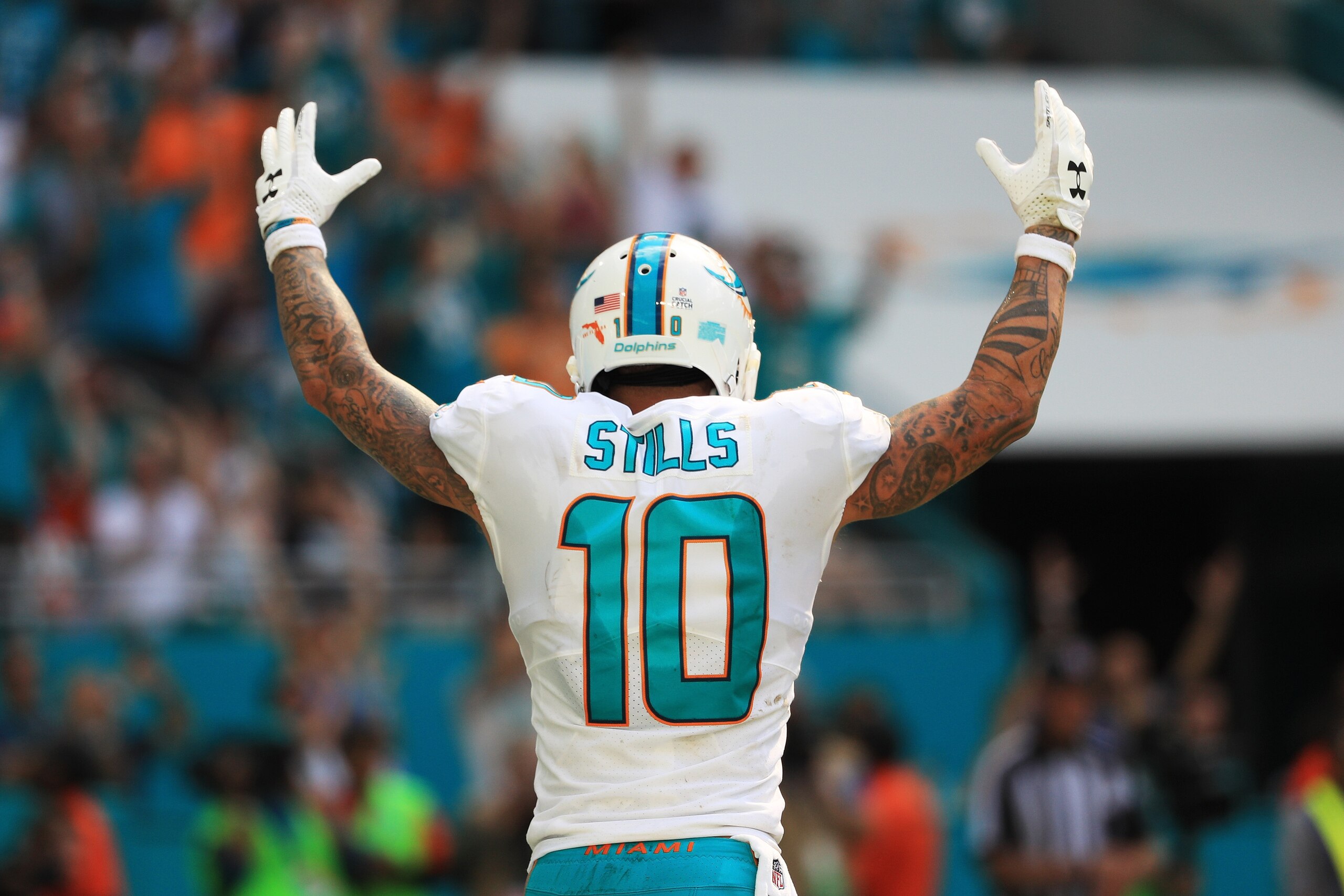 MIAMI GARDENS, FL - OCTOBER 08:   Kenny Stills #10 of the Miami Dolphins celebrates a touchdown by Jarvis Landry #14 in the fourth quarter against the Tennessee Titans on October 8, 2017 at Hard Rock Stadium in Miami Gardens, Florida.  (Photo by Mike Ehrm