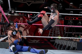 Finn Balor nails AJ Styles with a running dropkick at TLC.