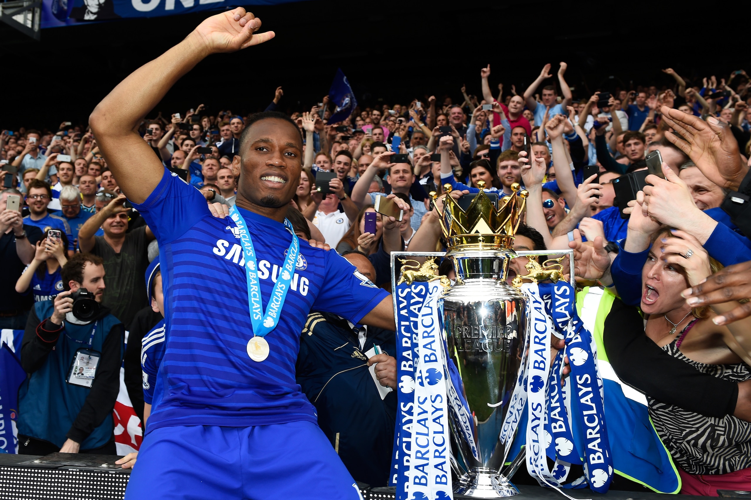 LONDON, ENGLAND - MAY 24: Didier Drogba of Chelsea celebrates with fans and the trophy after the Barclays Premier League match between Chelsea and Sunderland at Stamford Bridge on May 24, 2015 in London, England. Chelsea were crowned Premier League cham LONDON, ENGLAND - MAY 24: Didier Drogba of Chelsea celebrates with fans and the trophy after the Barclays Premier League match between Chelsea and Sunderland at Stamford Bridge on May 24, 2015 in London, England. Chelsea were crowned Premier League cham