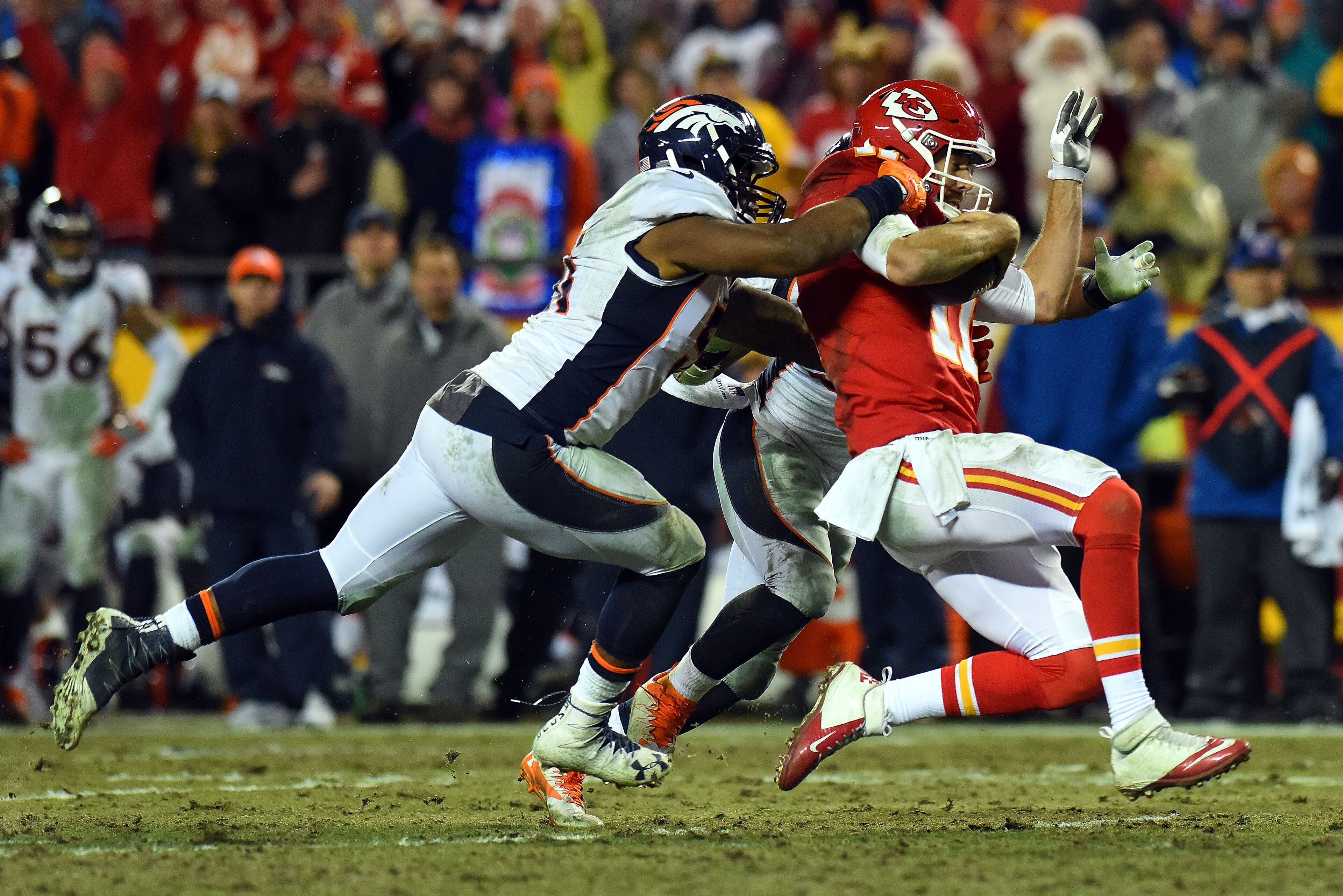 KANSAS CITY, MO - DECEMBER 25:  Quarterback Alex Smith #11 of the Kansas City Chiefs is tackled by inside linebacker Todd Davis #51 and inside linebacker Corey Nelson #52 of the Denver Broncos on a keeper during the game at Arrowhead Stadium on December 2