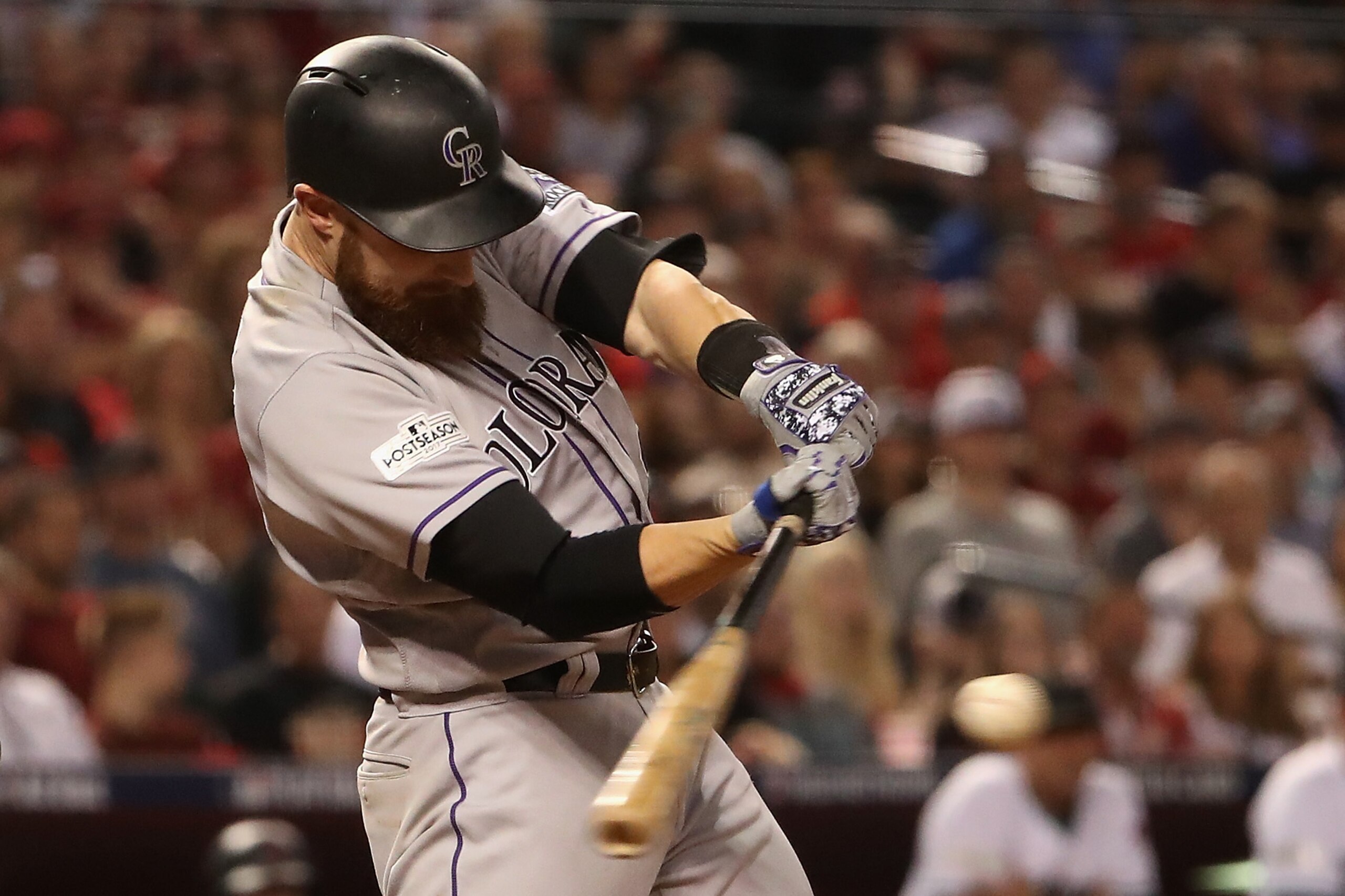 PHOENIX, AZ - OCTOBER 04:  Jonathan Lucroy #21 of the Colorado Rockies hits a RBI double during the fourth inning of the National League Wild Card game against the Arizona Diamondbacks at Chase Field on October 4, 2017 in Phoenix, Arizona.  (Photo by Chri