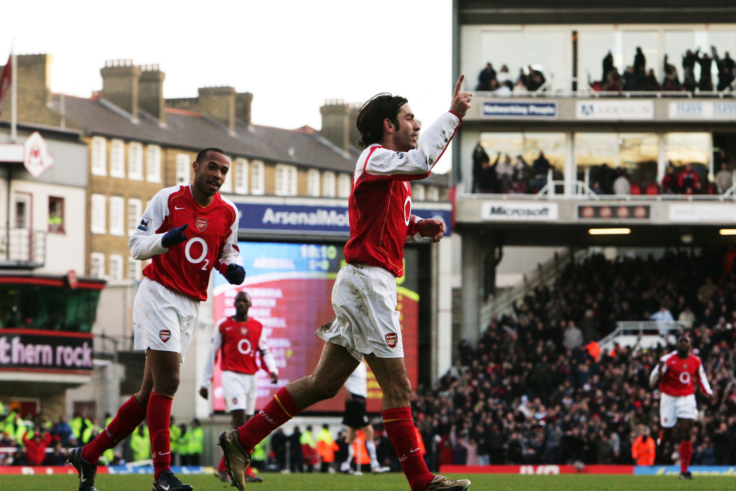 LONDON ENGLAND - DECEMBER 26. Thierry Henry (L) celebrates with Robert Pires of Arsenal after he scoring a goal during the Barclays Premiership match between Arsenal and Fulham at Highbury on December 26, 2004 in London, England. (Photo by Phil Cole/Getty