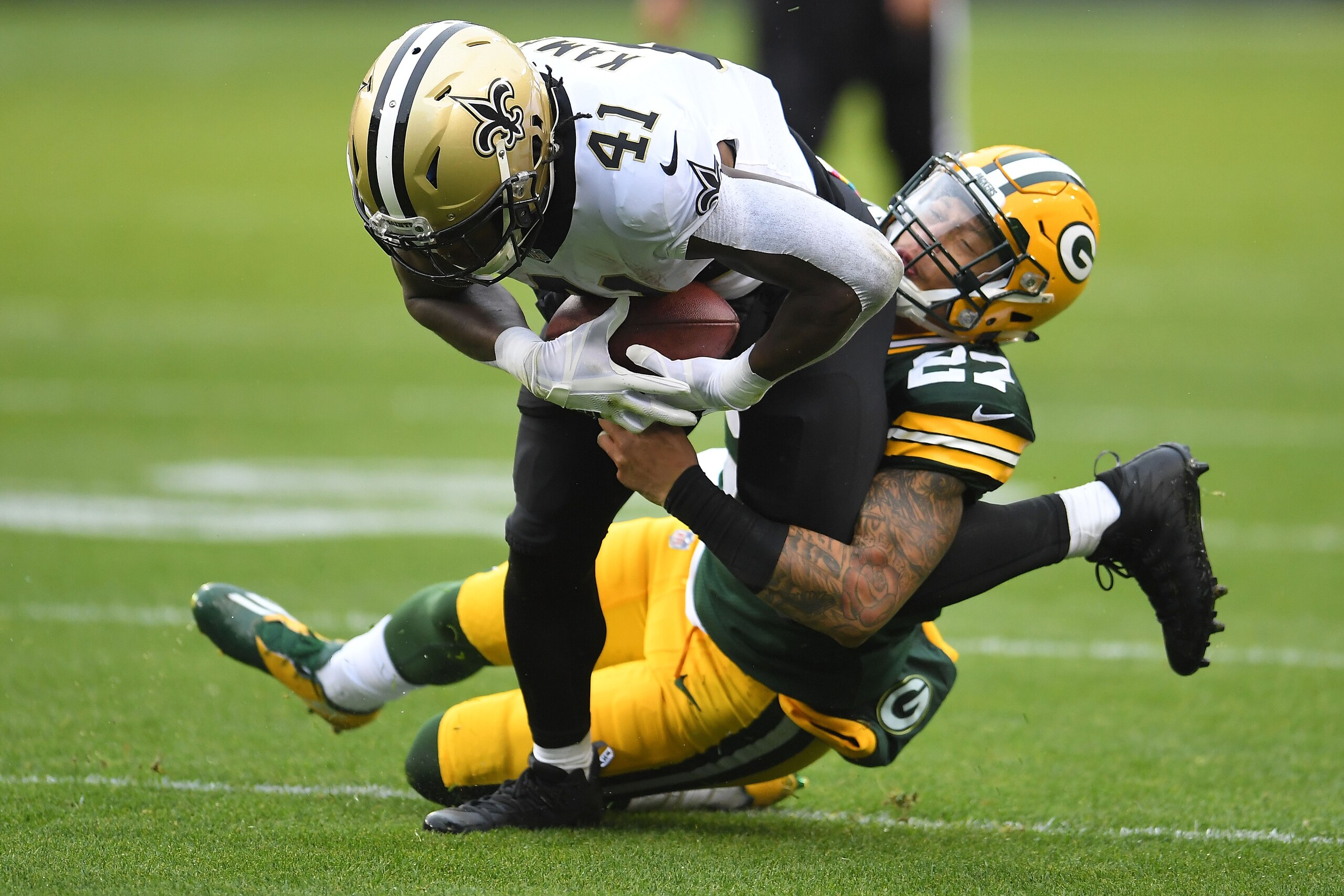 GREEN BAY, WI - OCTOBER 22: Alvin Kamara #41 of the New Orleans Saints is brought down by Josh Jones #27 of the Green Bay Packers during a game at Lambeau Field on October 22, 2017 in Green Bay, Wisconsin. The Saints defeated the Packers 26-17. (Photo GREEN BAY, WI - OCTOBER 22: Alvin Kamara #41 of the New Orleans Saints is brought down by Josh Jones #27 of the Green Bay Packers during a game at Lambeau Field on October 22, 2017 in Green Bay, Wisconsin. The Saints defeated the Packers 26-17. (Photo