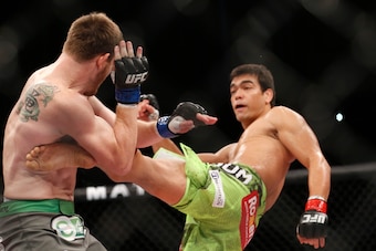 Machida fires a body kick at opponent CB Dollaway.