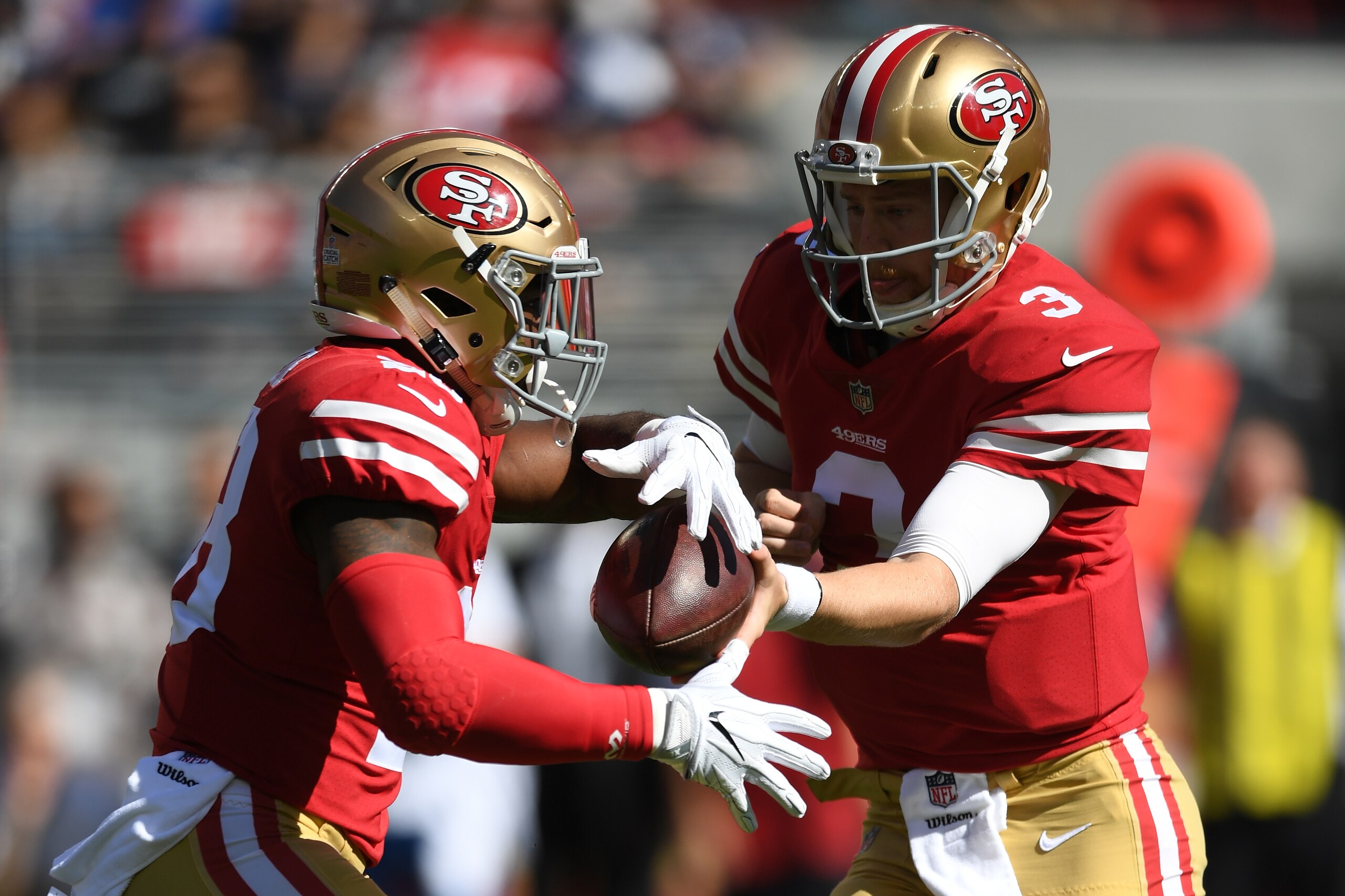 SANTA CLARA, CA - OCTOBER 22:  C.J. Beathard #3 of the San Francisco 49ers hands the ball off to Carlos Hyde #28 during their NFL game against the Dallas Cowboys at Levi's Stadium on October 22, 2017 in Santa Clara, California.  (Photo by Thearon W. Hende