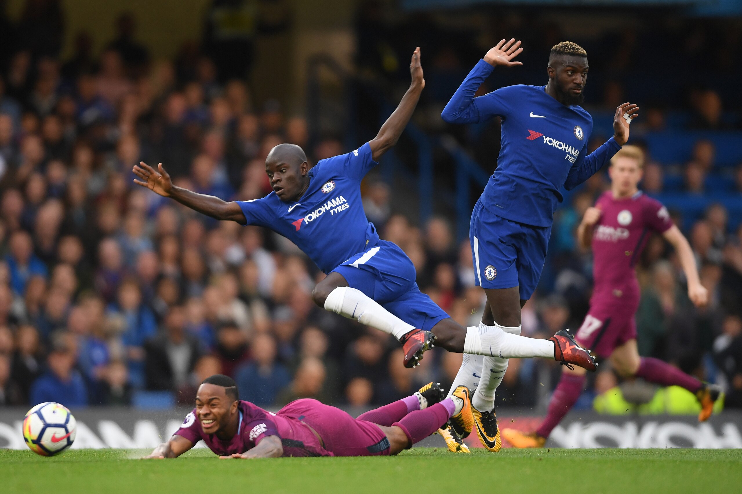 LONDON, ENGLAND - SEPTEMBER 30:  N'Golo Kante of Chelsea flies over the top of Raheem Sterling of Manchester City during the Premier League match between Chelsea and Manchester City at Stamford Bridge on September 30, 2017 in London, England.  (Photo by M