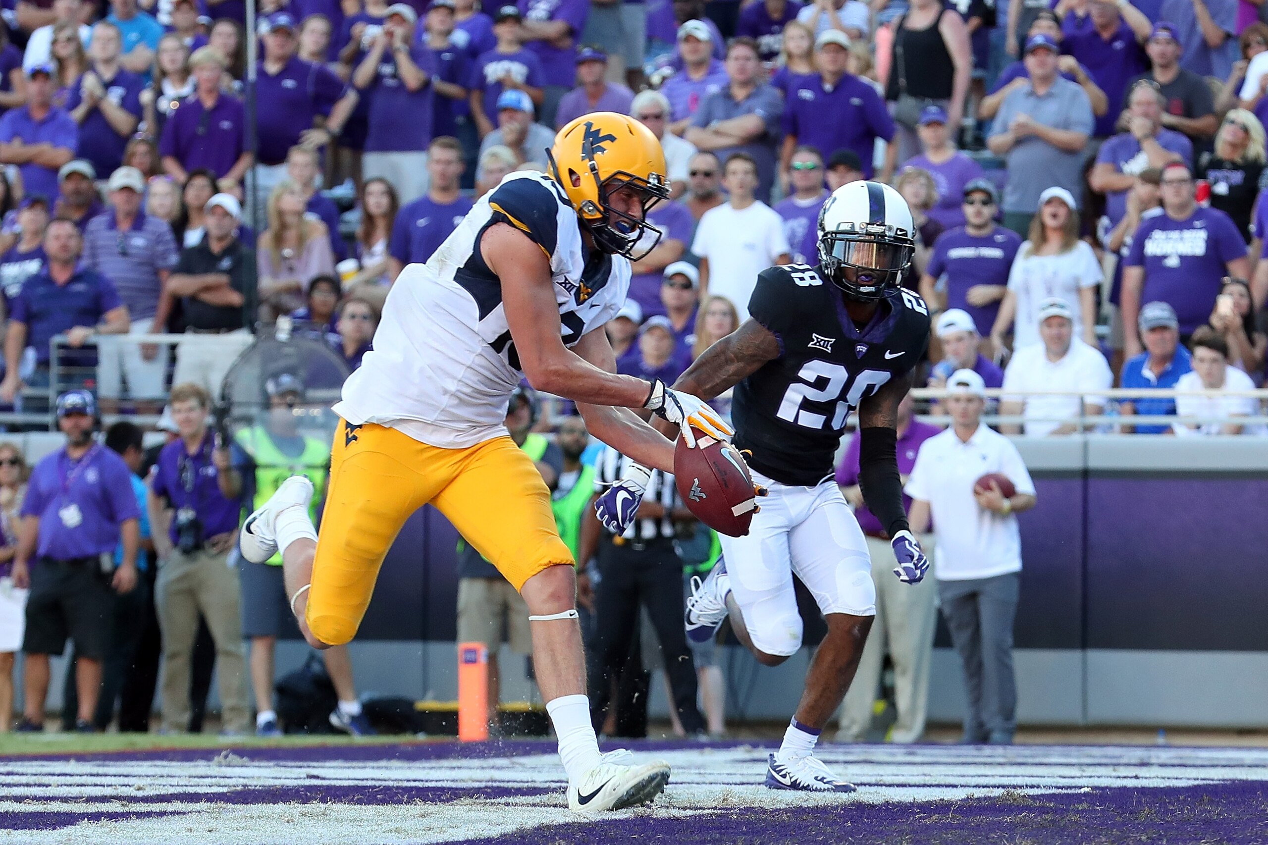 FORT WORTH, TX - OCTOBER 07:  David Sills V #13 of the West Virginia Mountaineers pulls in a pass for a touchdown against Tony James #28 of the TCU Horned Frogs in the second half at Amon G. Carter Stadium on October 7, 2017 in Fort Worth, Texas.  (Photo 