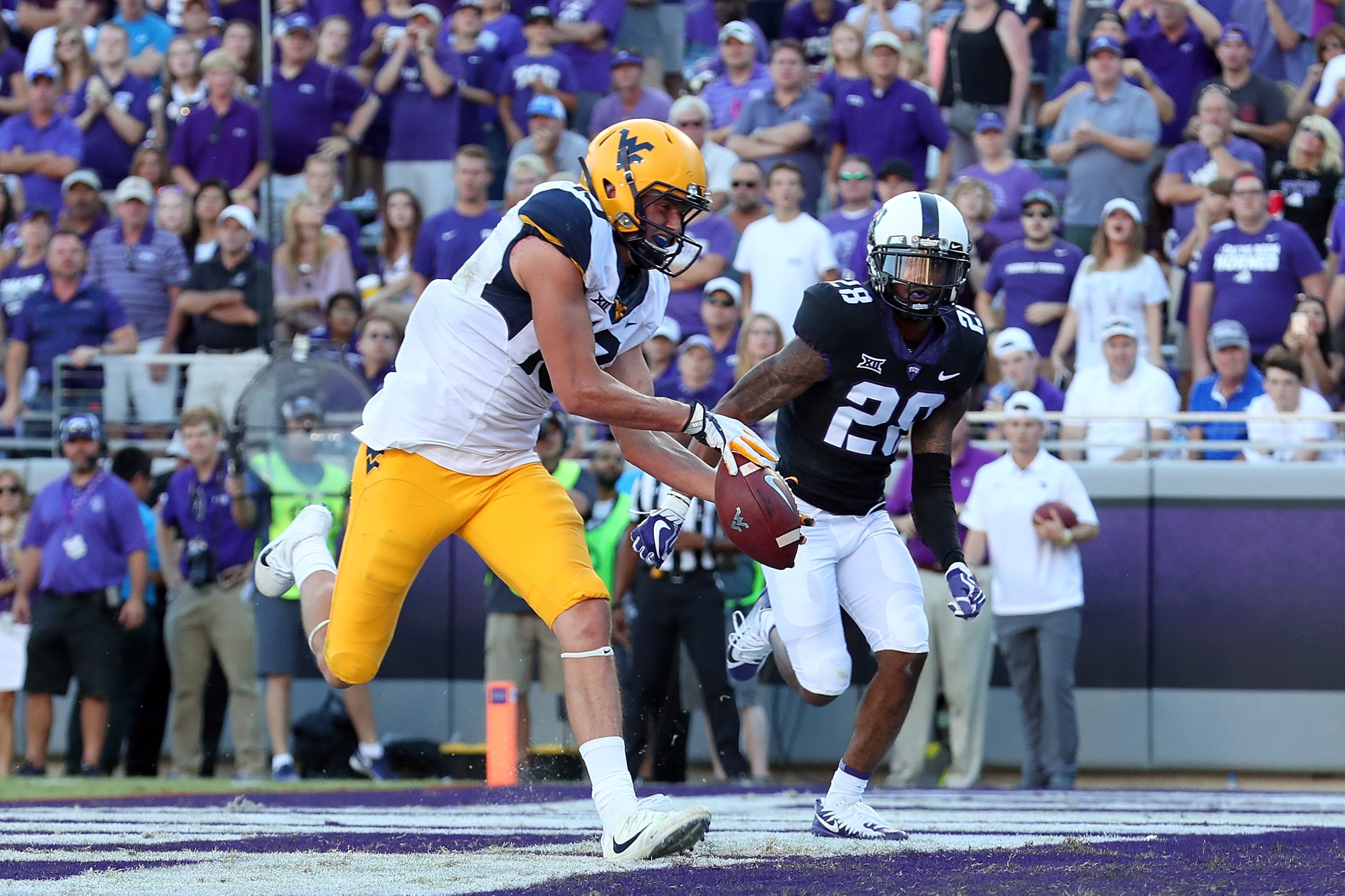FORT WORTH, TX - OCTOBER 07:  David Sills V #13 of the West Virginia Mountaineers pulls in a pass for a touchdown against Tony James #28 of the TCU Horned Frogs in the second half at Amon G. Carter Stadium on October 7, 2017 in Fort Worth, Texas.  (Photo 