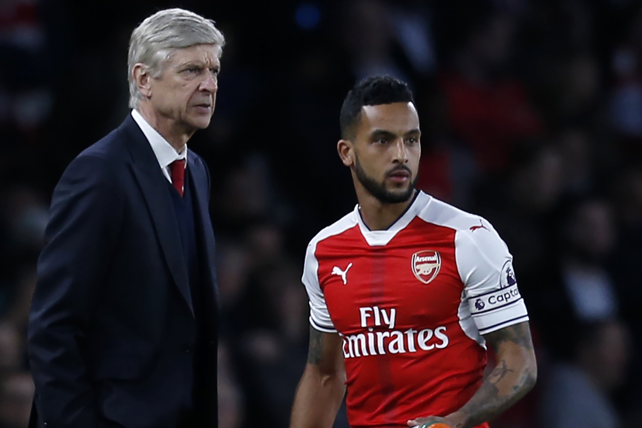 Arsenal's French manager Arsene Wenger gives instructions to his captain, Arsenal's English midfielder Theo Walcott ahead of the English Premier League football match between Arsenal and West Ham United at the Emirates Stadium in London on April 5, 2017. 