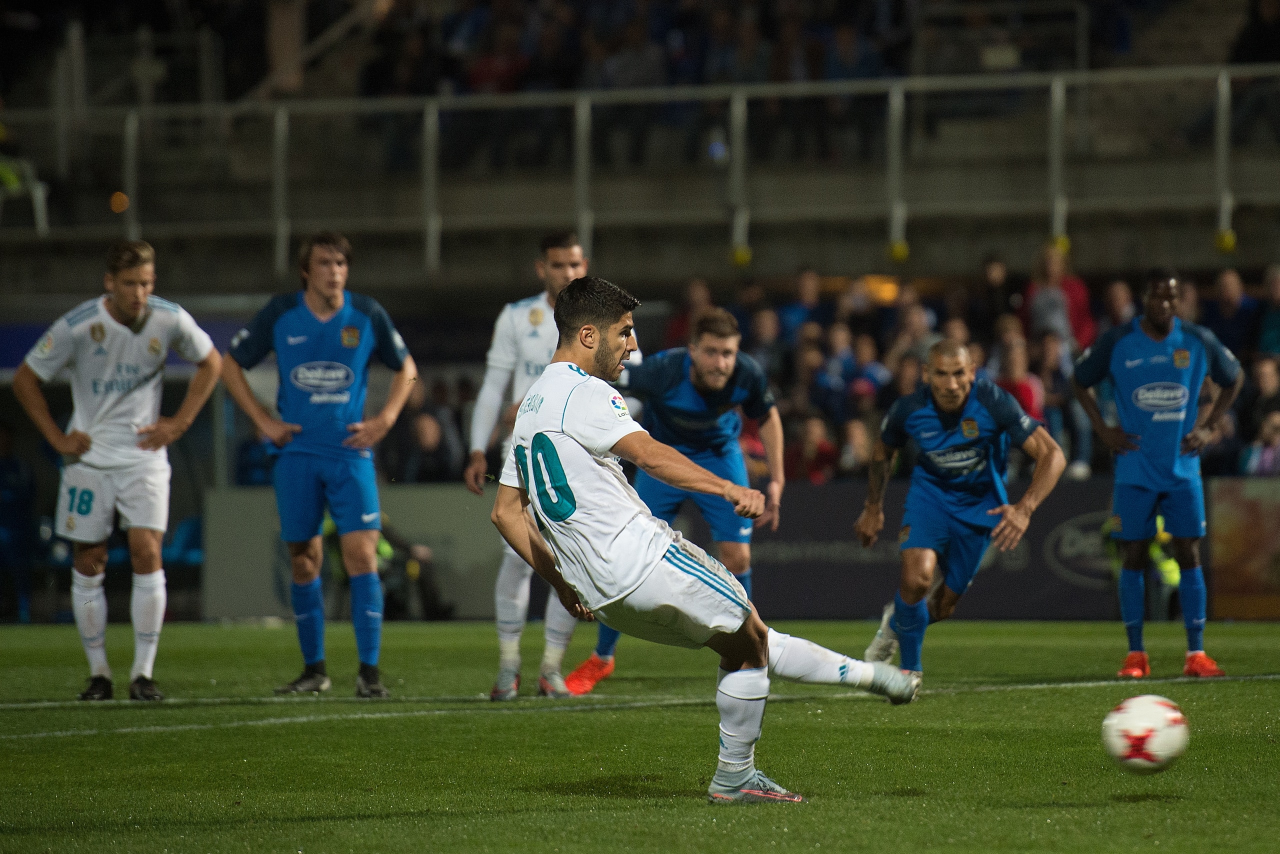 MADRID, SPAIN - OCTOBER 26: Marco Asensio of Real Madrid CF scores his team's opening goal from a penalty kick during the Copa del Rey, Round of 32, First Leg match between Fuenlabrada and Real Madrid at Estadio Fernando Torres on October 26, 2017 in Madr