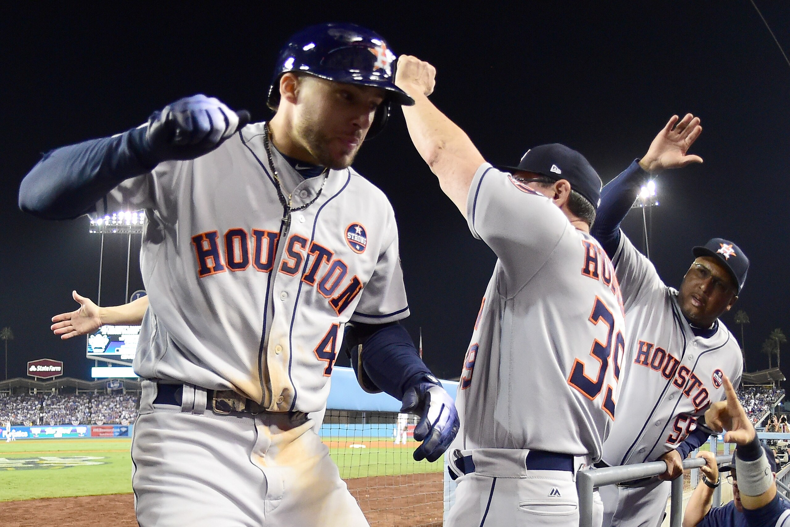 LOS ANGELES, CA - OCTOBER 25:  George Springer #4 of the Houston Astros celebrates in the dugout after hitting a two-run home run during the eleventh inning against the Los Angeles Dodgers in game two of the 2017 World Series at Dodger Stadium on October 