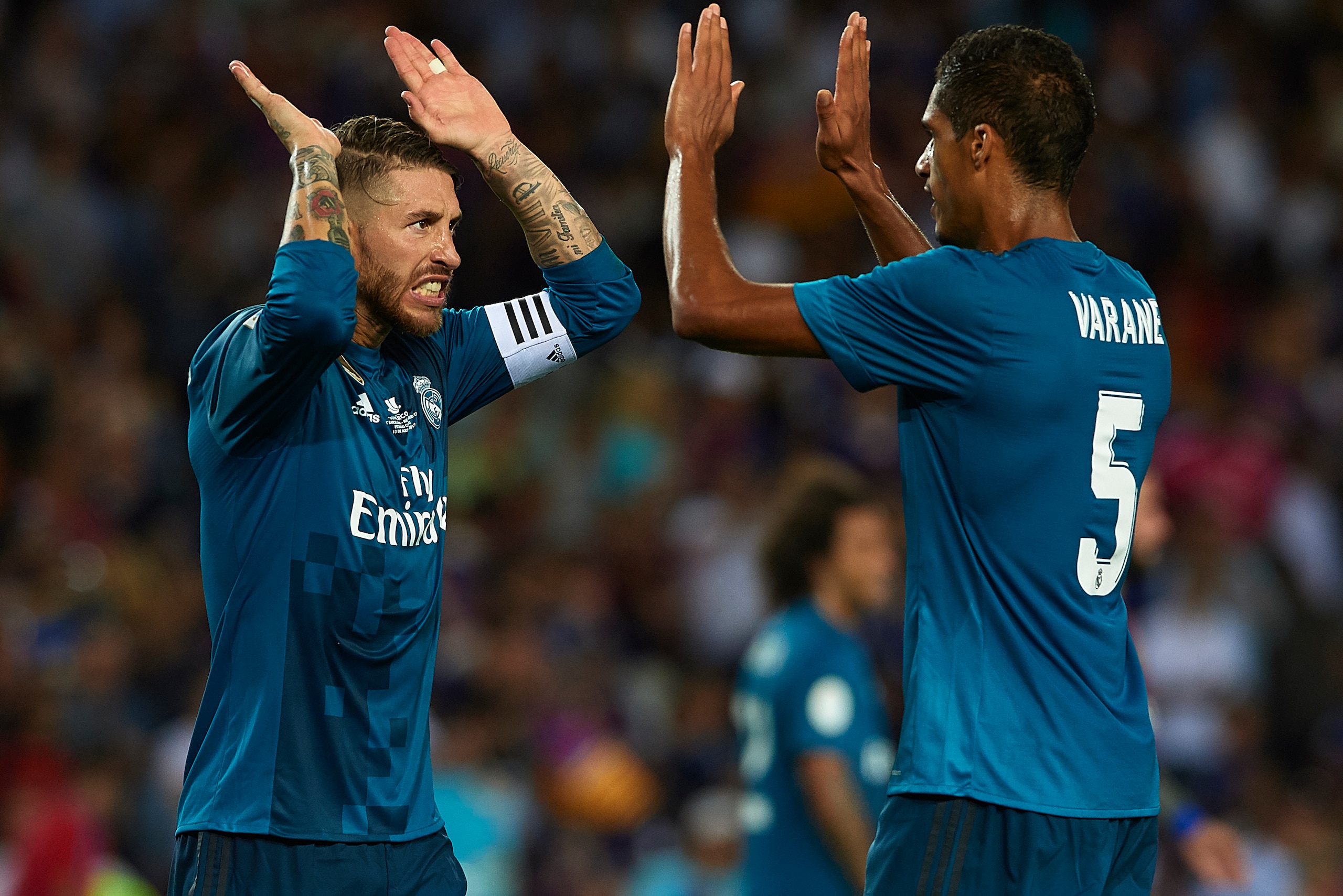 BARCELONA, SPAIN - AUGUST 13: Sergio Ramos of Real Madrid celebrates with his teammate Raphael Varane after the end the Supercopa de Espana Supercopa Final 1st Leg match between FC Barcelona and Real Madrid at Camp Nou on August 13, 2017 in Barcelona, Sp BARCELONA, SPAIN - AUGUST 13: Sergio Ramos of Real Madrid celebrates with his teammate Raphael Varane after the end the Supercopa de Espana Supercopa Final 1st Leg match between FC Barcelona and Real Madrid at Camp Nou on August 13, 2017 in Barcelona, Sp