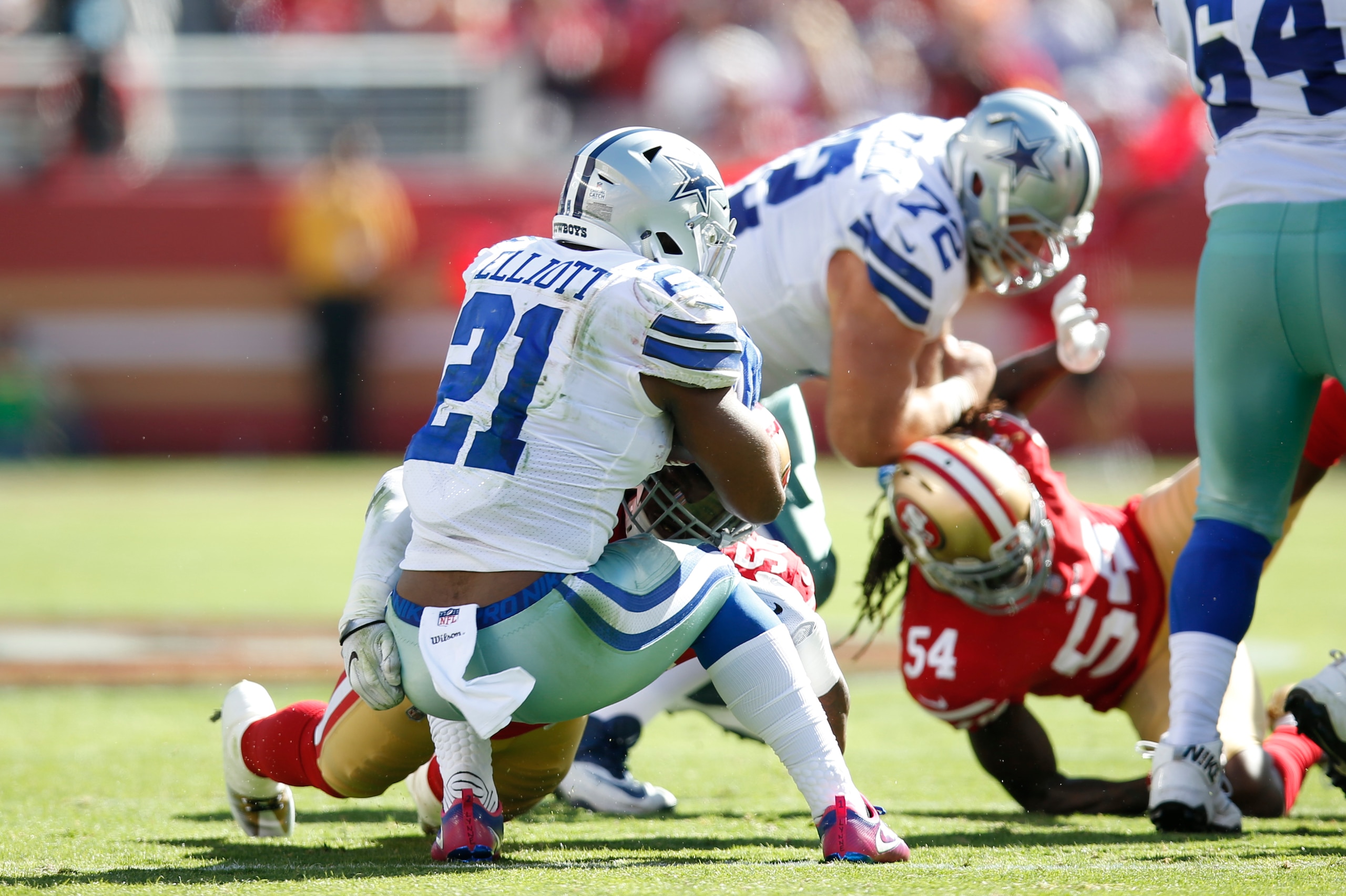 SANTA CLARA, CA - OCTOBER 22: Reuben Foster #56 of the San Francisco 49ers tackles Ezekiel Elliott #21 of the Dallas Cowboys during the game at Levi's Stadium on October 22, 2017 in Santa Clara, California. The Cowboys defeated the 49ers 40-10. (Photo by 