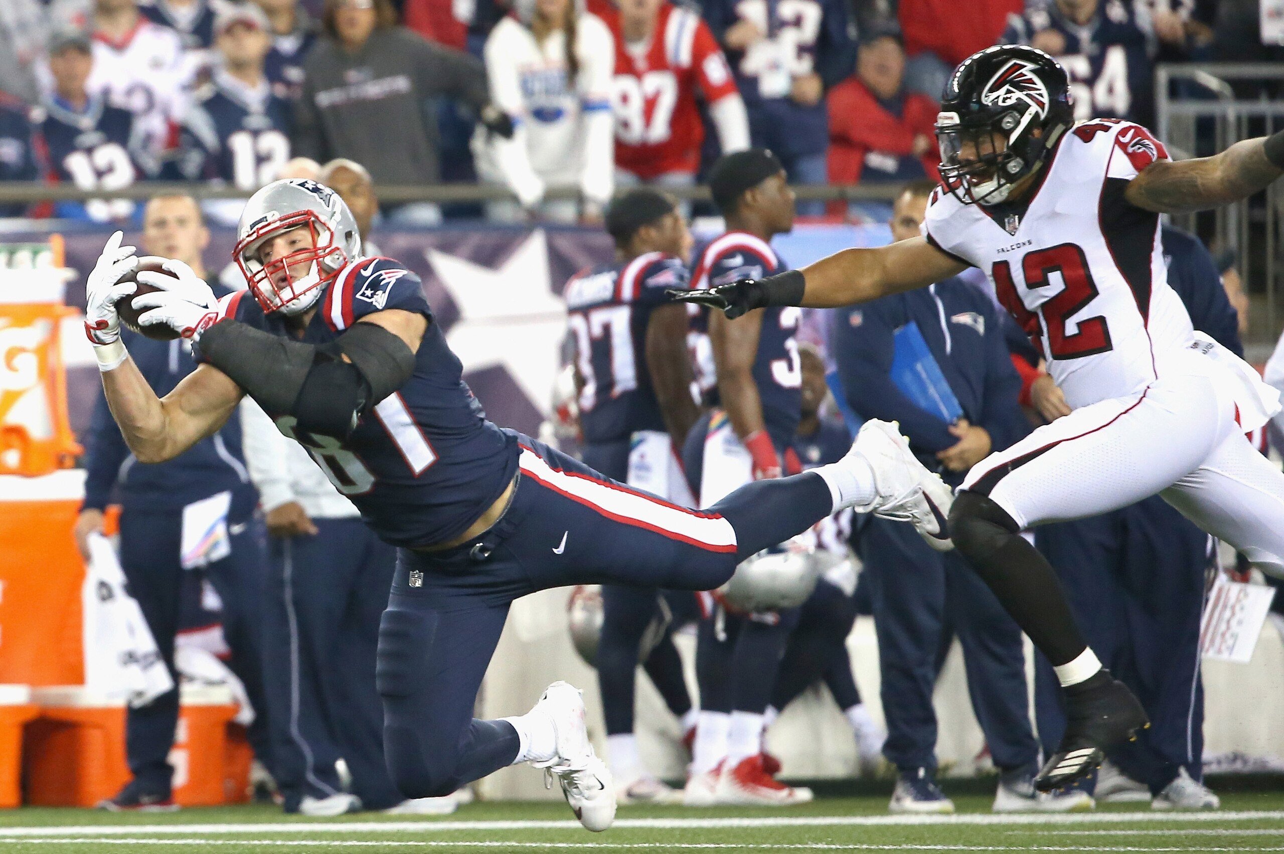 FOXBORO, MA - OCTOBER 22:  Rob Gronkowski #87 of the New England Patriots makes a diving catch as he is defended by Duke Riley #42 of the Atlanta Falcons during the first quarter of a game at Gillette Stadium on October 22, 2017 in Foxboro, Massachusetts.