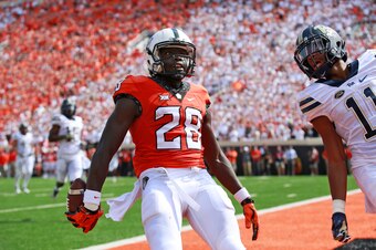 STILLWATER, OK - SEPTEMBER 17 :  Wide receiver James Washington #28 of the Oklahoma State Cowboys looks to the crowd after scoring in front of defensive back Dane Jackson #11 of the Pittsburgh Panthers September 17, 2016 at Boone Pickens Stadium in Stillw
