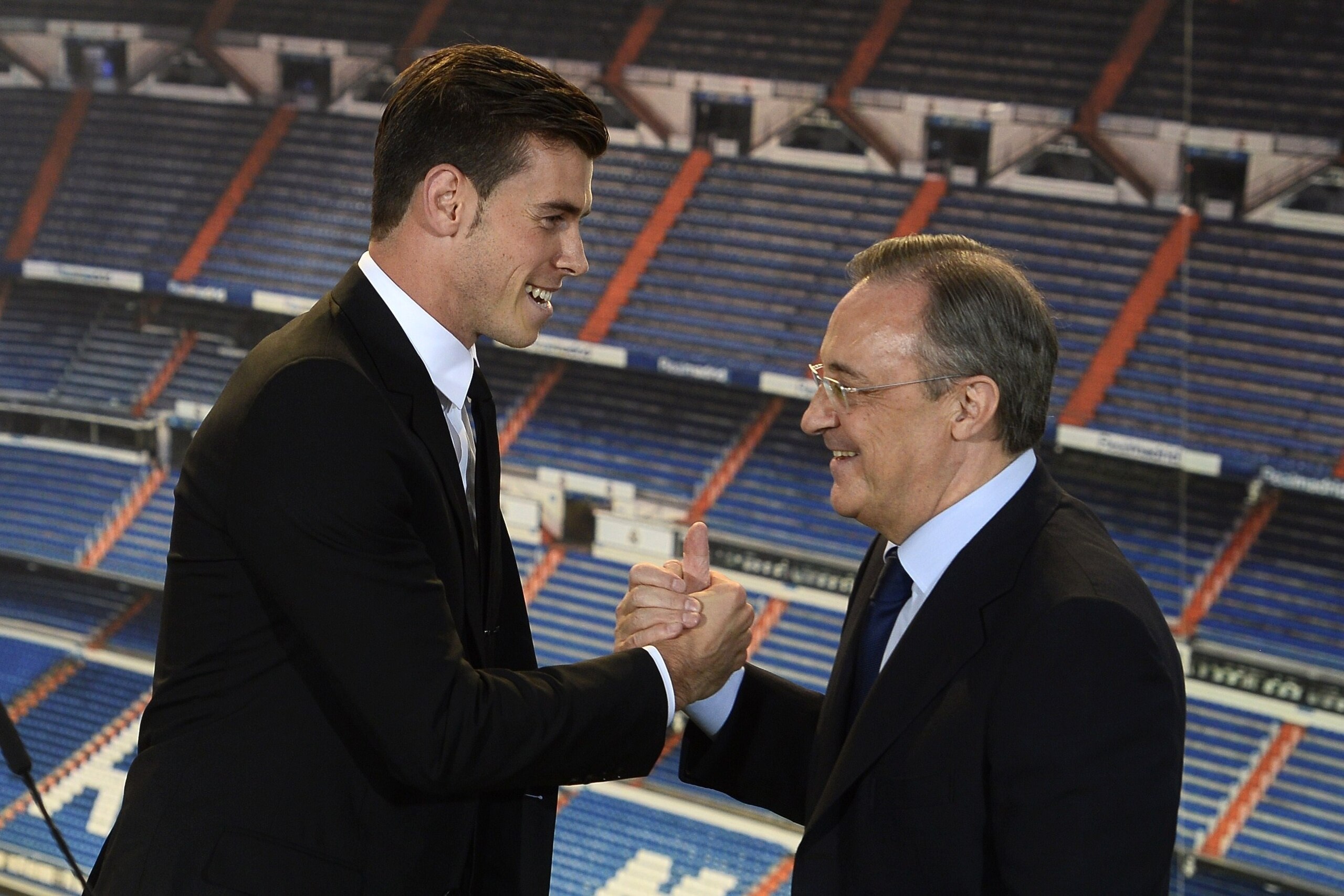 New Welsh striker Gareth Bale of Real Madrid (L) is welcomed by Real Madrid's President Florentino Perez during his presentation at the Santiago Bernabeu stadium in Madrid on September 2, 2013. Bale was unveiled as a Real Madrid player today after his pro