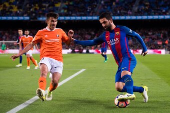 BARCELONA, SPAIN - APRIL 26:  Arda Turan of FC Barcelona dribbles Aitor Bunuel of CA Osasuna during the La Liga match between FC Barcelona and CA Osasuna at Camp Nou stadium on April 26, 2017 in Barcelona, Spain.  (Photo by Alex Caparros/Getty Images)