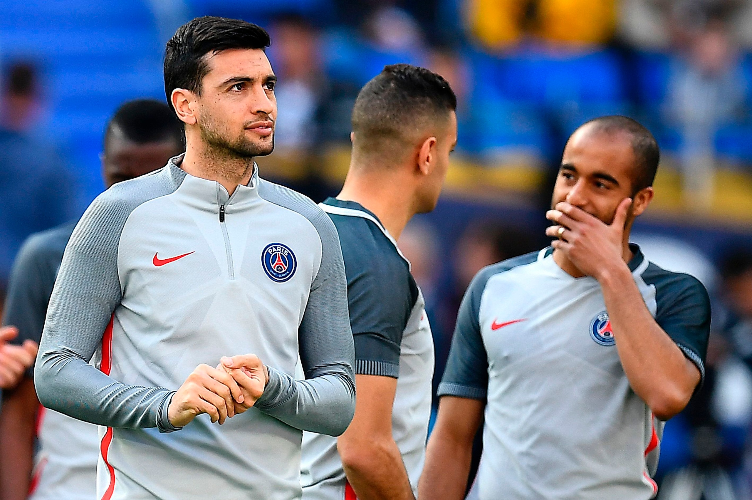 Paris Saint-Germain's Argentinian forward Javier Pastore (L) and Paris Saint-Germain's Brazilian midfielder Lucas Moura (R) arrive for a training session at the Parc Olympique Lyonnais stadium in Decines-Charpieu near Lyon on March 31, 2017, on the eve of