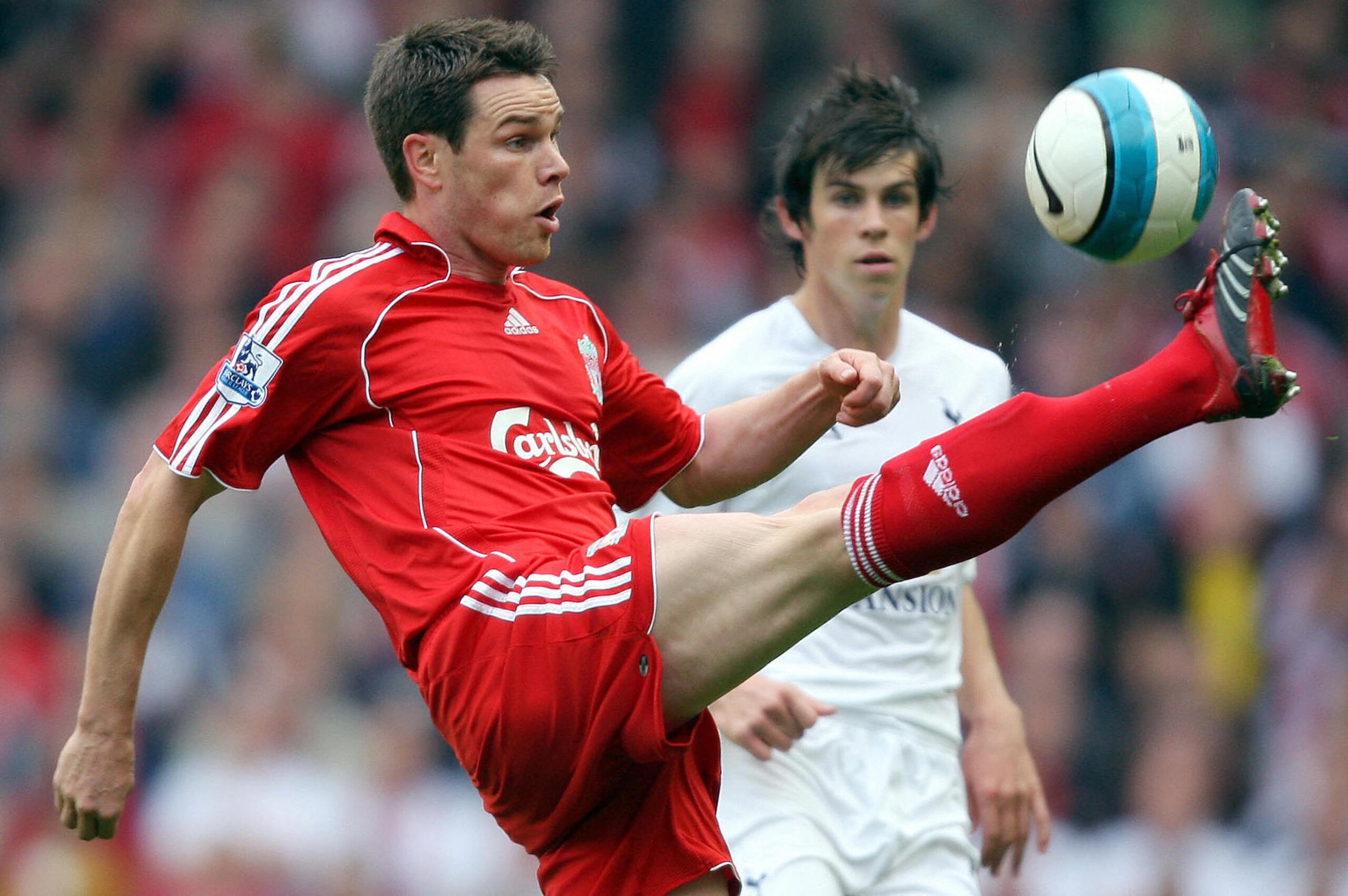 Steve Finnan (L) of Liverpool clears the ball from Gareth Bale of Tottenham Hotspur during the Premier league football match at Anfield, Liverpool, north-west, England, 07 October, 2007. AFP PHOTO/ANDREW YATES  Mobile and website use of domestic English f