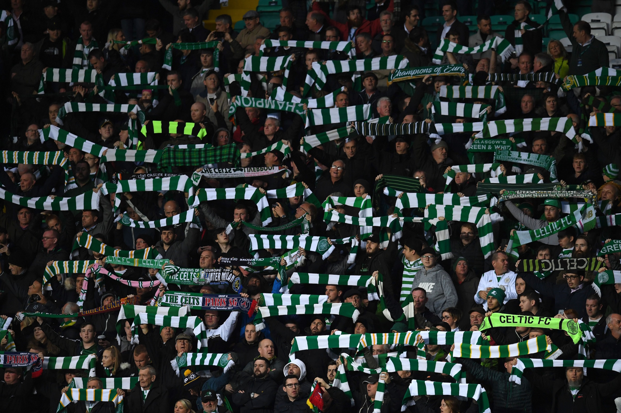 Fans wave scarves and flags during the UEFA Champions League Group B football match between Celtic and Paris Saint-Germain (PSG) at Celtic Park in Glasgow, on September 12, 2017.
Paris Saint-Germain won the match 5-0. / AFP PHOTO / Paul ELLIS (Phot Fans wave scarves and flags during the UEFA Champions League Group B football match between Celtic and Paris Saint-Germain (PSG) at Celtic Park in Glasgow, on September 12, 2017.
Paris Saint-Germain won the match 5-0. / AFP PHOTO / Paul ELLIS (Phot