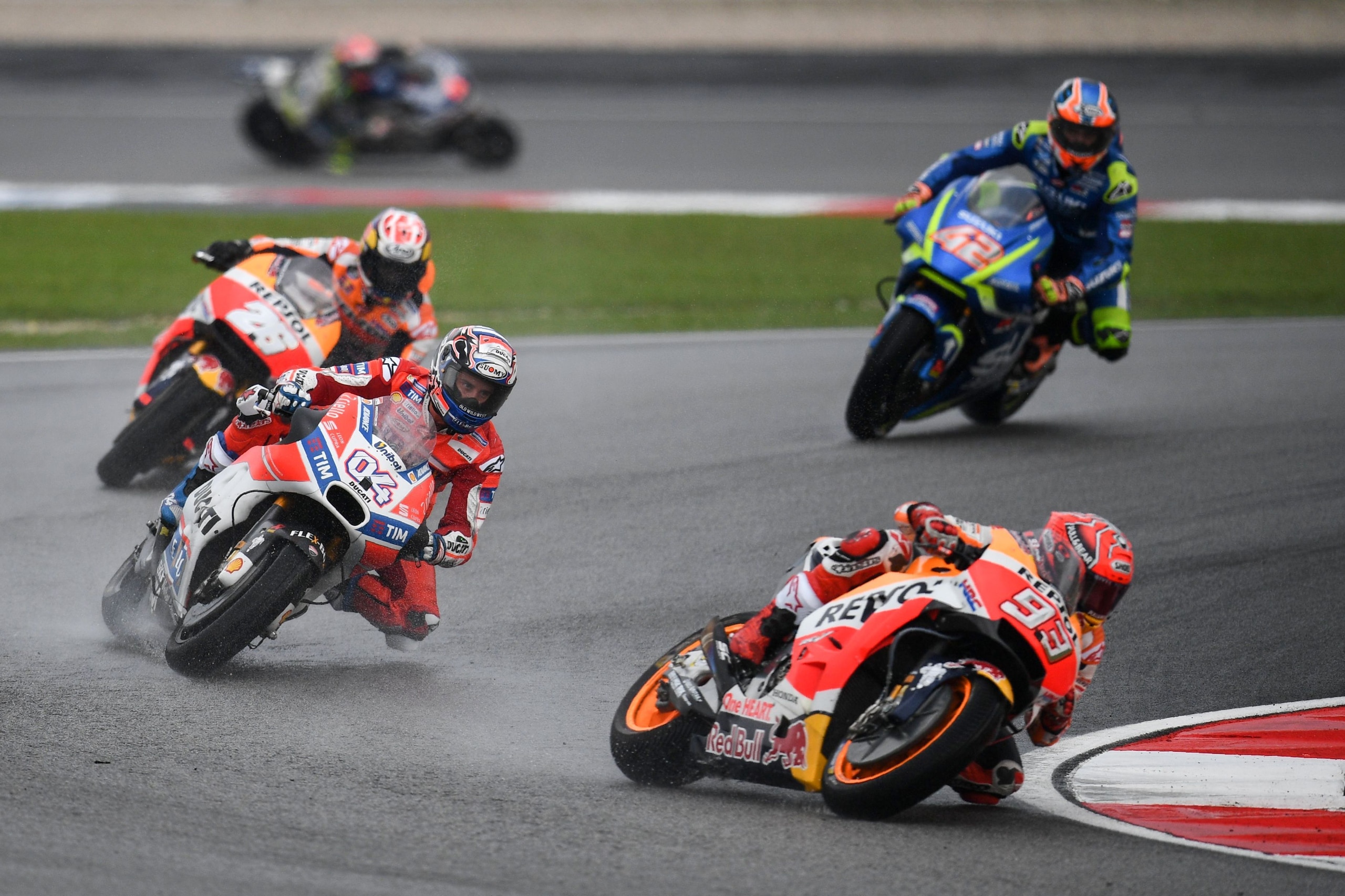 Repsol Hondas Spanish rider Marc Marquez leads the pack during the start of the Malaysia MotoGP at the Sepang International circuit on October 29, 2017. / AFP PHOTO / MANAN VATSYAYANA        (Photo credit should read MANAN VATSYAYANA/AFP/Getty Images)