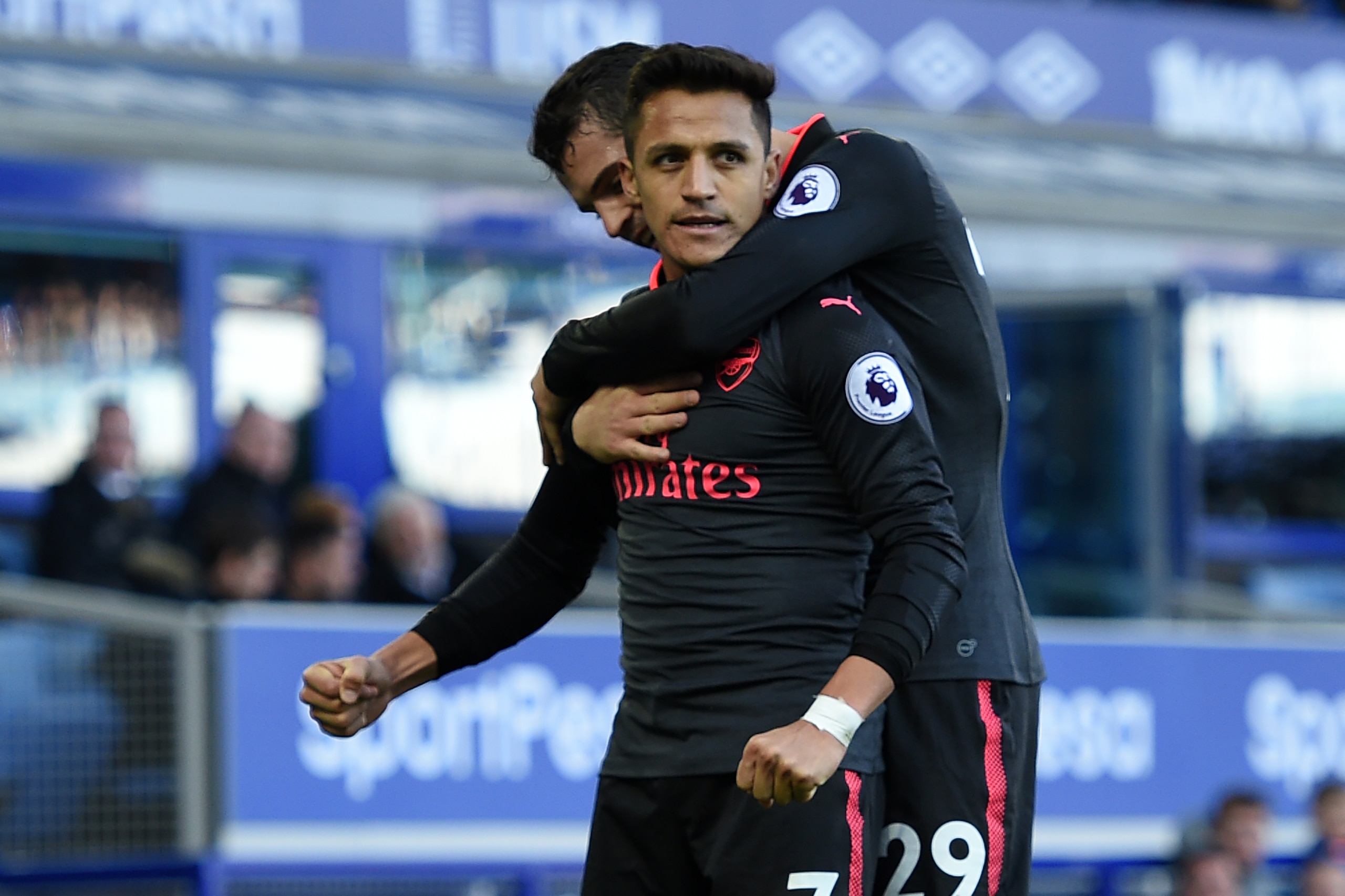 Arsenal's Chilean striker Alexis Sanchez (L) celebrates scoring their fifth goal with Arsenal's Swiss midfielder Granit Xhaka (R) during the English Premier League football match between Everton and Arsenal at Goodison Park in Liverpool, north west Englan