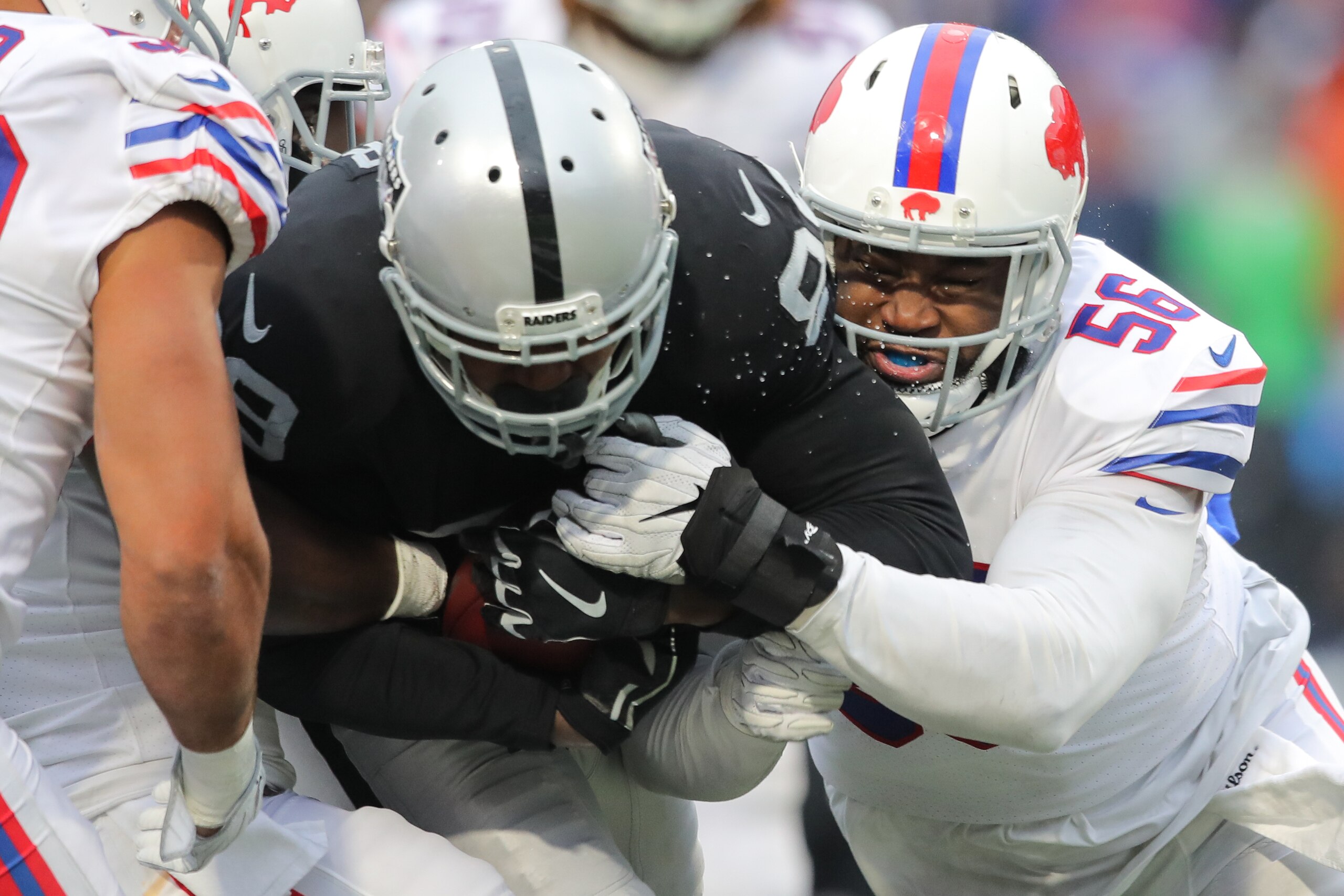 ORCHARD PARK, NY - OCTOBER 29: Amari Cooper #89 of the Oakland Raiders runs the ball as Ryan Davis #56 of the Buffalo Bills attempts to tackle him during the fourth quarter of an NFL game on October 29, 2017 at New Era Field in Orchard Park, New York. (Ph