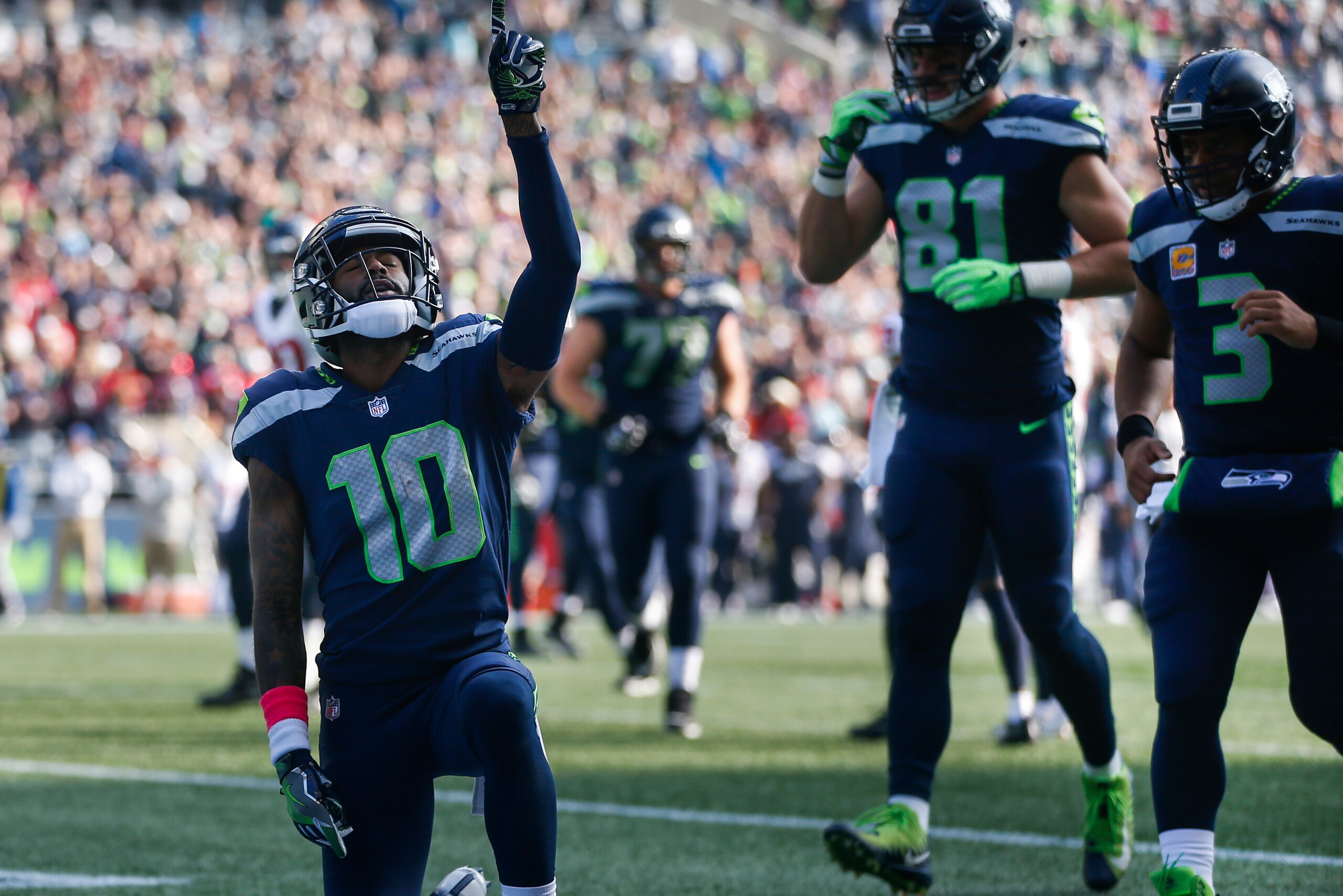 SEATTLE, WA - OCTOBER 29: Wide receiver Paul Richardson #10 of the Seattle Seahawks celebrates his touchdown as Nick Vannett #81 and Russell Wilson #3 run over to join him during the second quarter of the game against the Houston Texans at CenturyLink Fie
