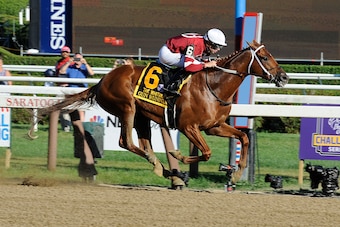 SARATOGA SPRINGS, NEW YORK- AUGUST 5: Gun Runner with Florent Geroux up with horseshoe attached to his tail wins the Whitney Stakes at Saratoga Race Course on August 5, 2017 in Saratoga Springs, NY (Photo by Horsephotos/Getty Images)