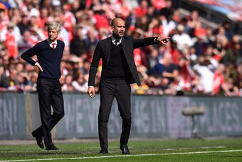 Arsenal's French manager Arsene Wenger (L) and Manchester City's Spanish manager Pep Guardiola gesture on the touchline during the FA Cup semi-final football match between Arsenal and Manchester City at Wembley stadium in London on April 23, 2017. / AFP P