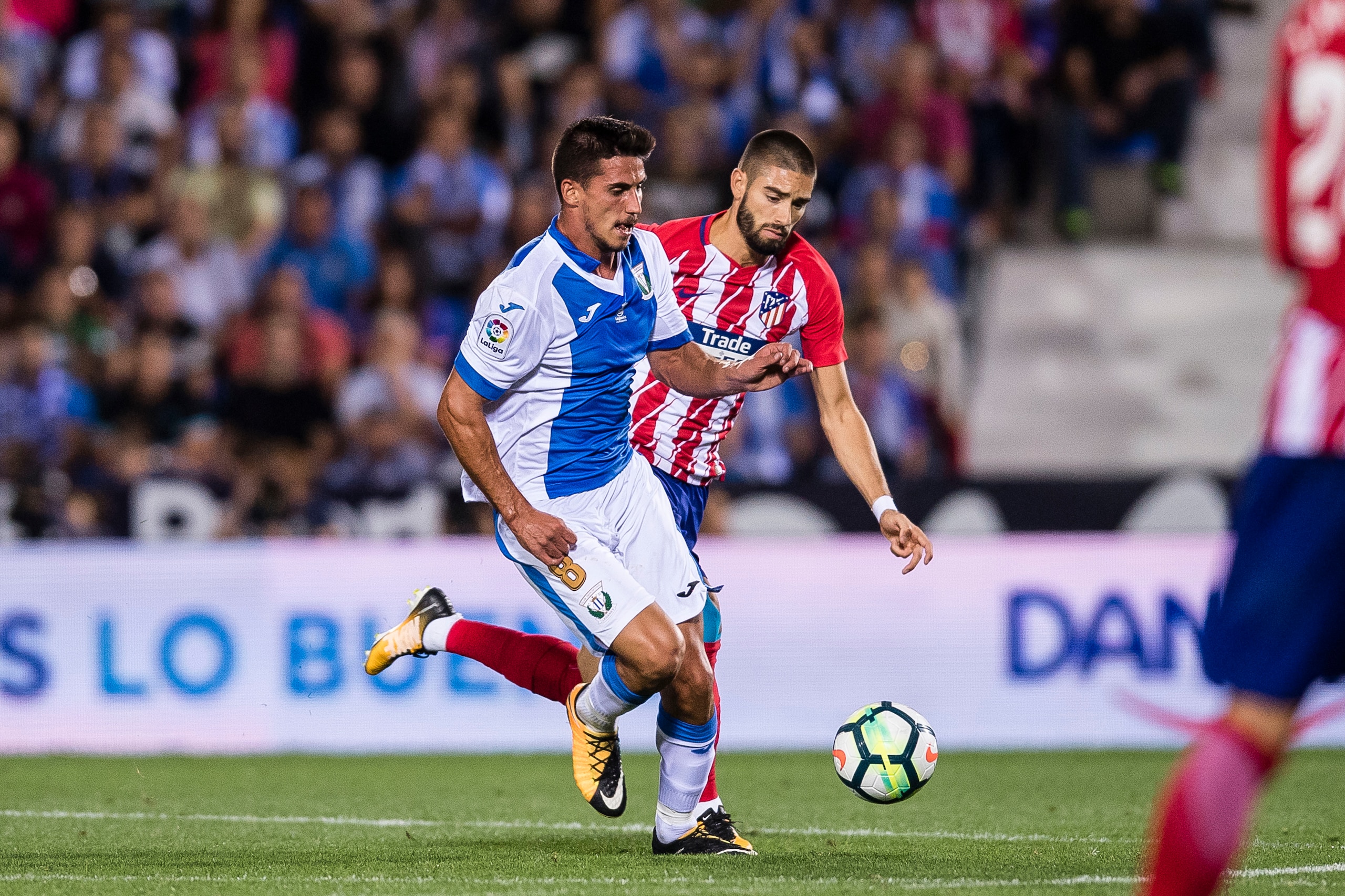 MADRID, SPAIN - SEPTEMBER 30: Gabriel Appelt Pires of CD Leganes (L) fights for the ball with Yannick Ferreira Carrasco of Atletico de Madrid during the La Liga 2017-18 match between CD Leganes and Atletico de Madrid on 30 September 2017 in Madrid, Spain.