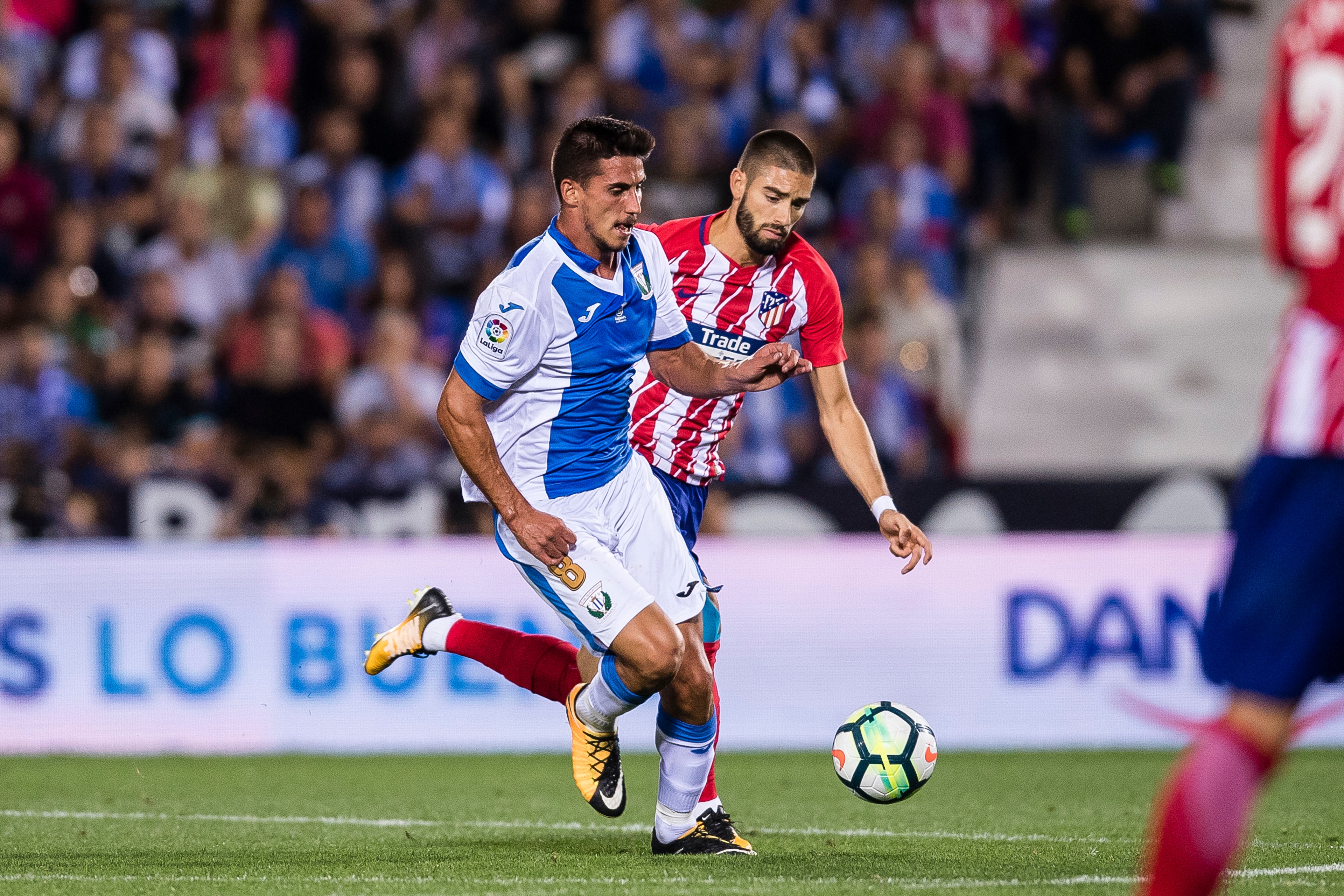 MADRID, SPAIN - SEPTEMBER 30: Gabriel Appelt Pires of CD Leganes (L) fights for the ball with Yannick Ferreira Carrasco of Atletico de Madrid during the La Liga 2017-18 match between CD Leganes and Atletico de Madrid on 30 September 2017 in Madrid, Spain.