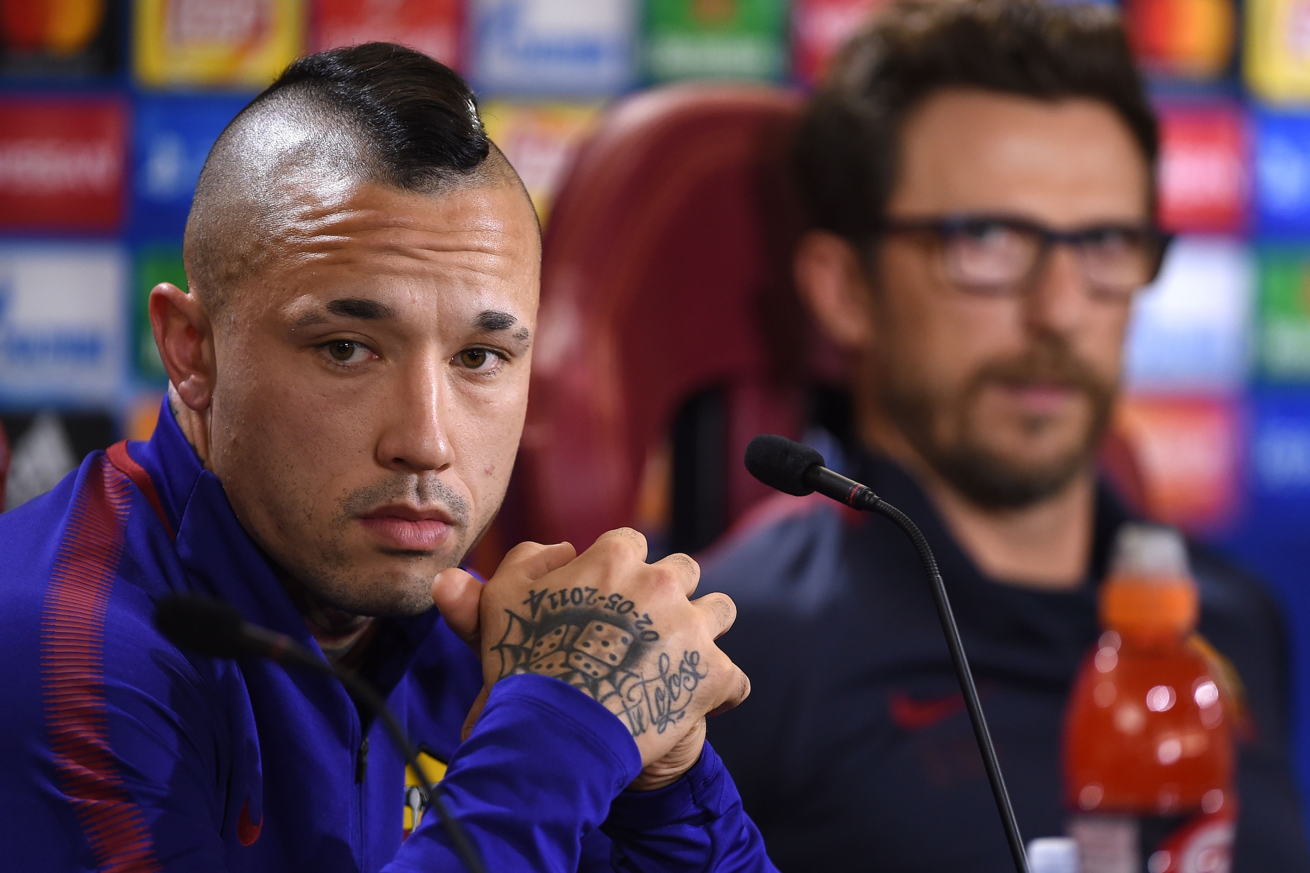 AS Roma's midfielder from Belgium Radja Nainggolan (L) and AS Roma's headcoach Eusebio Di Francesco (R) attend a press conference on the eve of the UEFA Champions League football match AS Roma vs Chelsea, on October 30, 2017 at the AS Roma training camp i