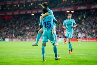 BILBAO, SPAIN - OCTOBER 28:  Paulinho of FC Barcelona celebrates with his teammates Lionel Messi of FC Barcelona after scoring his team's second goal during the La Liga match between Athletic Club Bilbao and FC Barcelona at San Mames Stadium on October 28