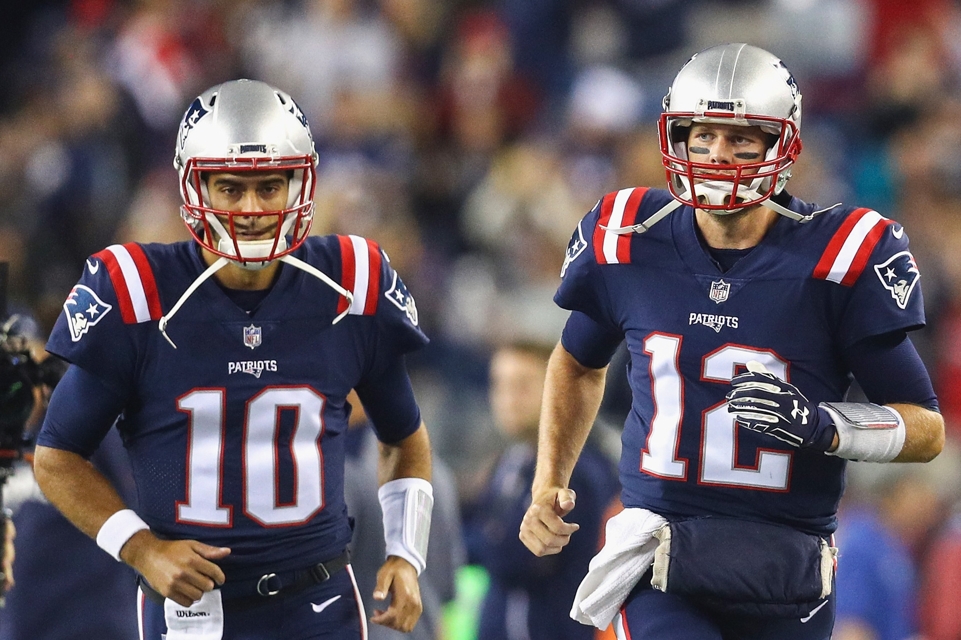 FOXBORO, MA - OCTOBER 22:  Tom Brady #12 and Jimmy Garoppolo #10 of the New England Patriots run onto the field before a game against the Atlanta Falcons at Gillette Stadium on October 22, 2017 in Foxboro, Massachusetts.  (Photo by Maddie Meyer/Getty Imag