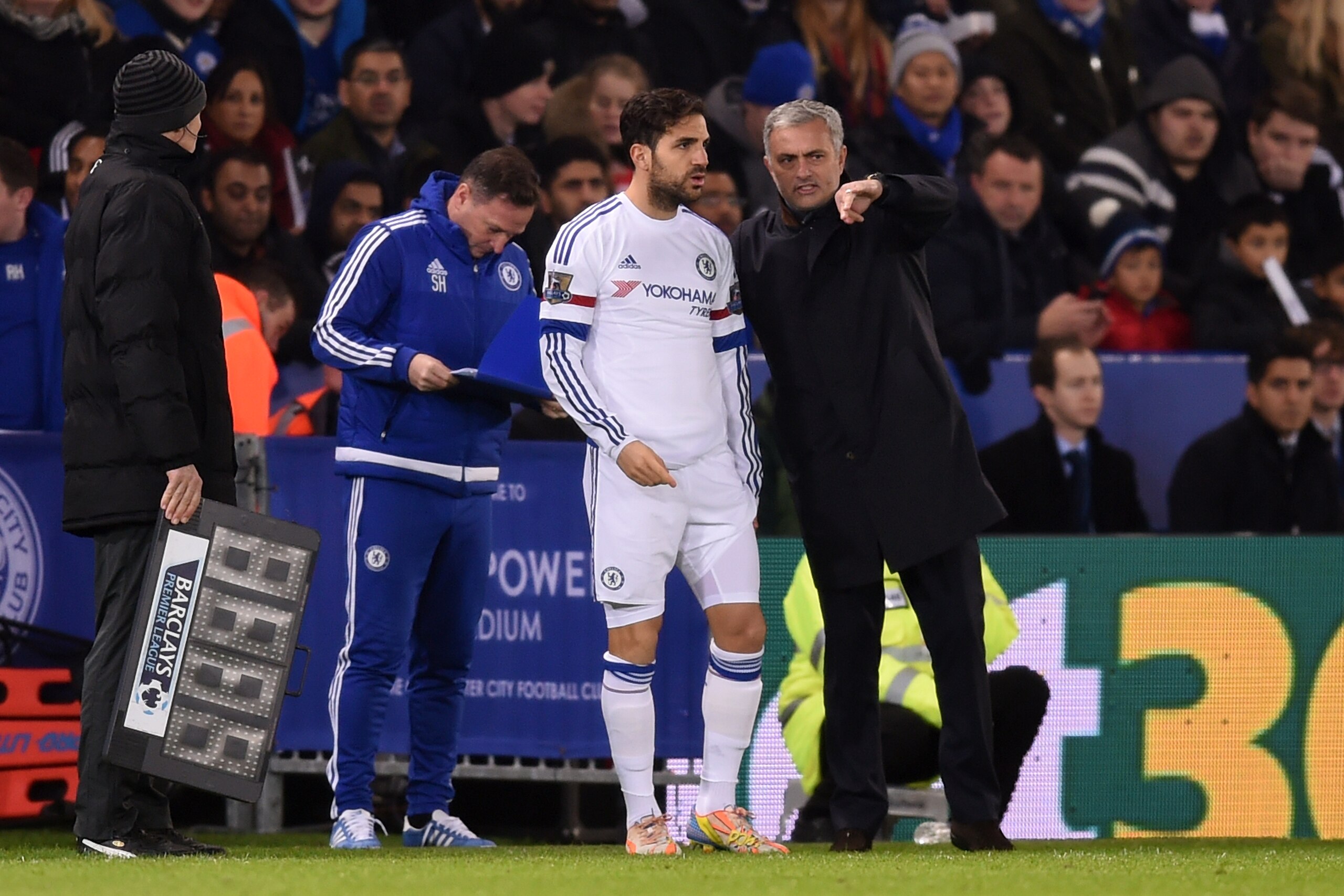 LEICESTER, ENGLAND - DECEMBER 14:  Cesc Fabregas of Chelsea speaks with Jose Mourinho the manager of Chelsea as he prepares to come on as a substitue during the Barclays Premier League match between Leicester City and Chelsea at the King Power Stadium on 