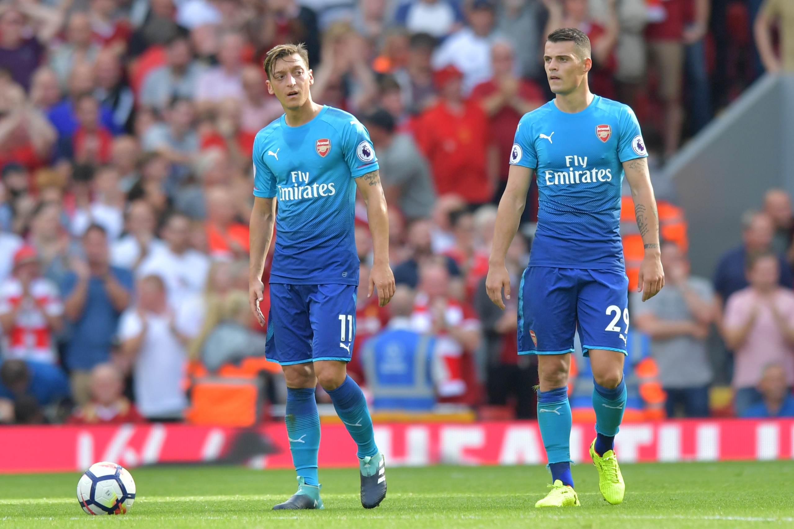 Arsenal's German midfielder Mesut Ozil (L) and Arsenal's Swiss midfielder Granit Xhaka react after conceding their fourth goal during the English Premier League football match between Liverpool and Arsenal at Anfield in Liverpool, north west England on Au