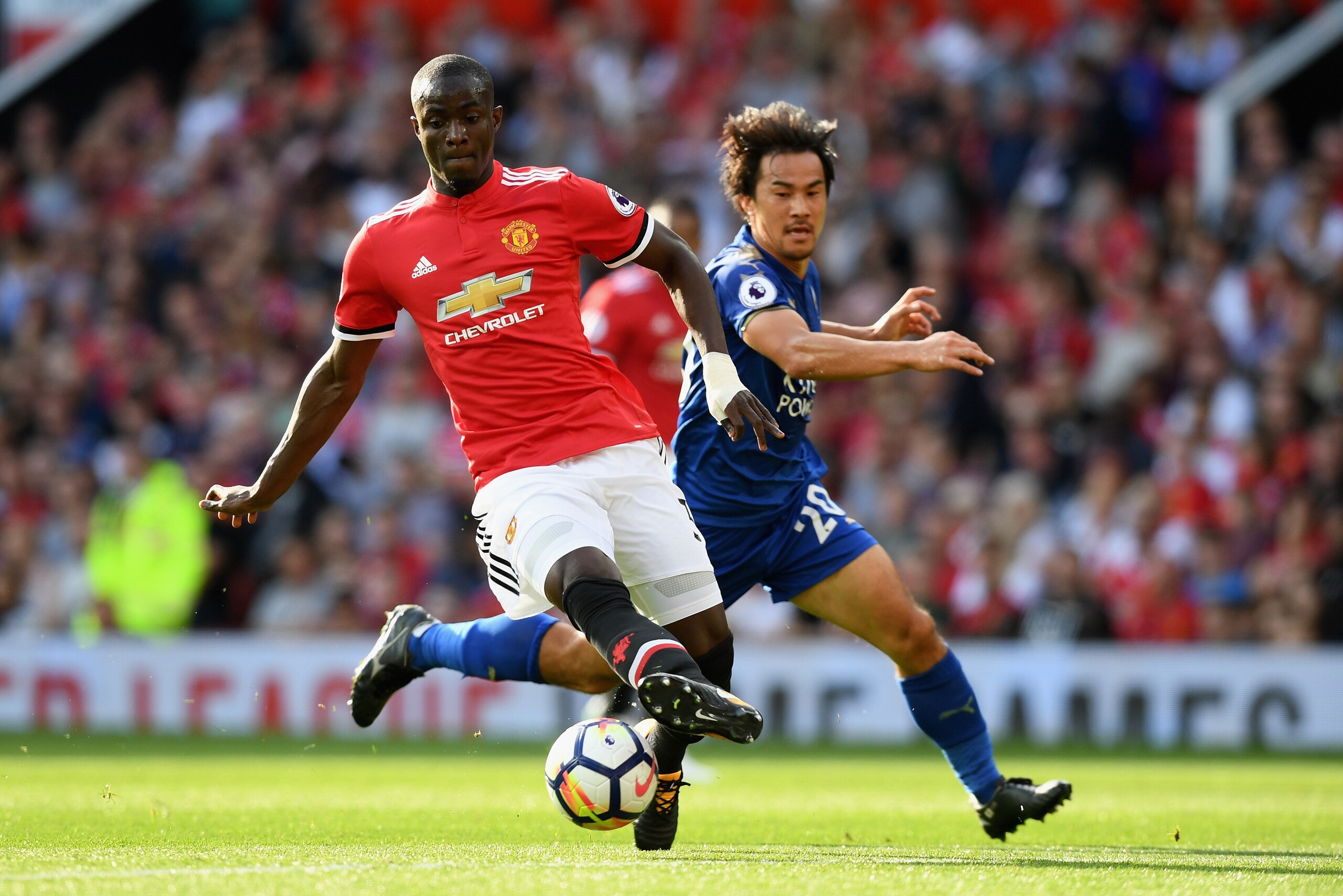 MANCHESTER, ENGLAND - AUGUST 26: Shinji Okazaki of Leicester City puts pressure on Eric Bailly of Manchester United during the Premier League match between Manchester United and Leicester City at Old Trafford on August 26, 2017 in Manchester, England.  (P