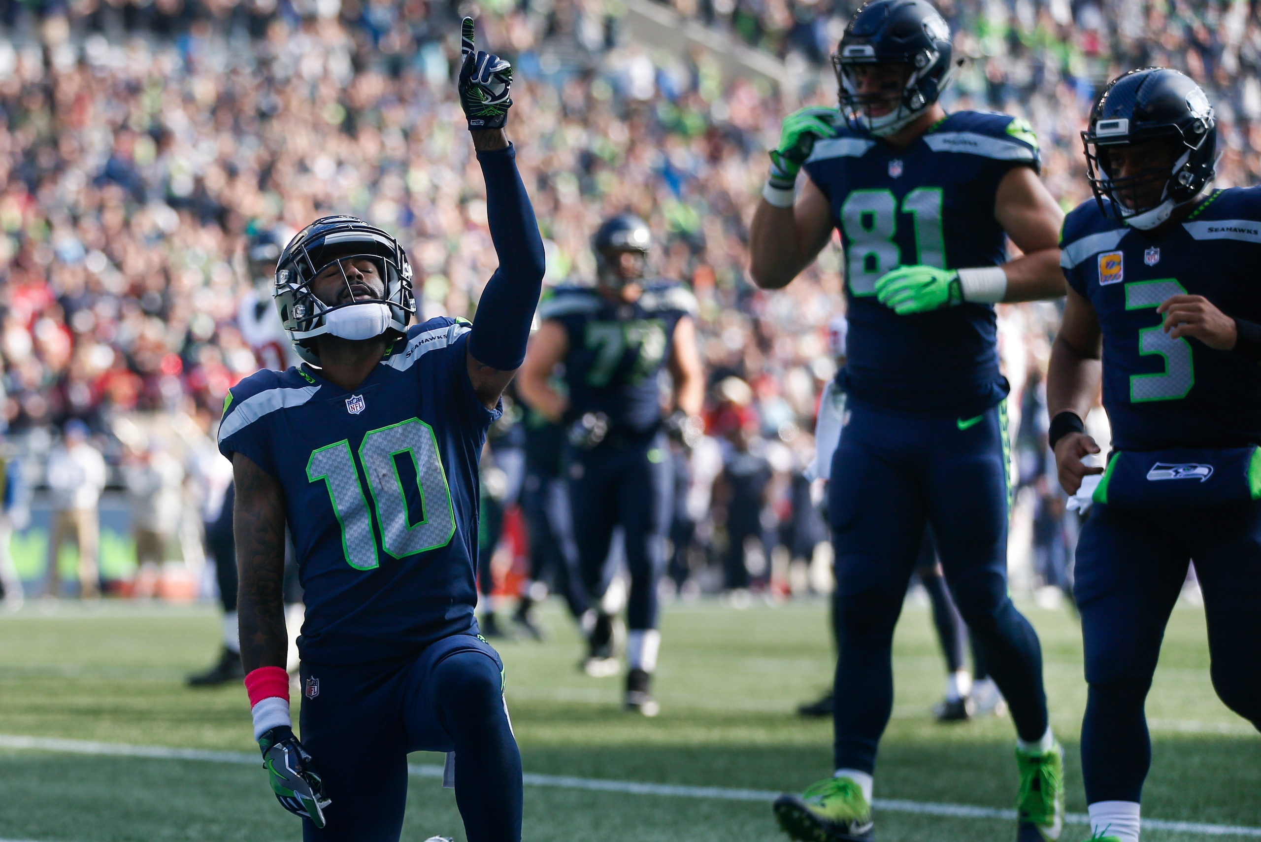 SEATTLE, WA - OCTOBER 29: Wide receiver Paul Richardson #10 of the Seattle Seahawks celebrates his touchdown as Nick Vannett #81 and Russell Wilson #3 run over to join him during the second quarter of the game against the Houston Texans at CenturyLink Fie