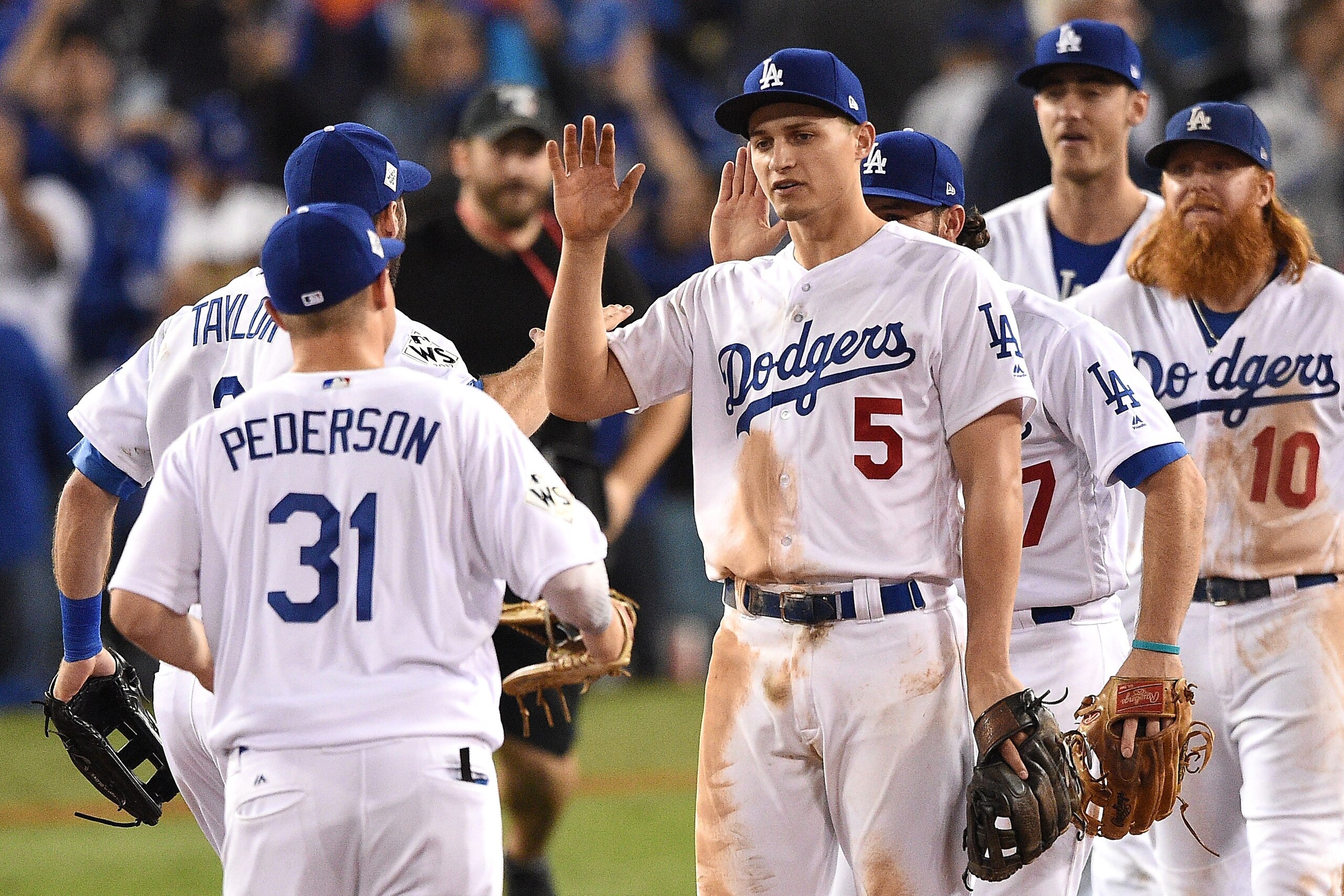 LOS ANGELES, CA - OCTOBER 31:  Corey Seager #5 of the Los Angeles Dodgers celebrates with teammates after defeating the Houston Astros 3-1 in game six of the 2017 World Series at Dodger Stadium on October 31, 2017 in Los Angeles, California.  (Photo by Ke